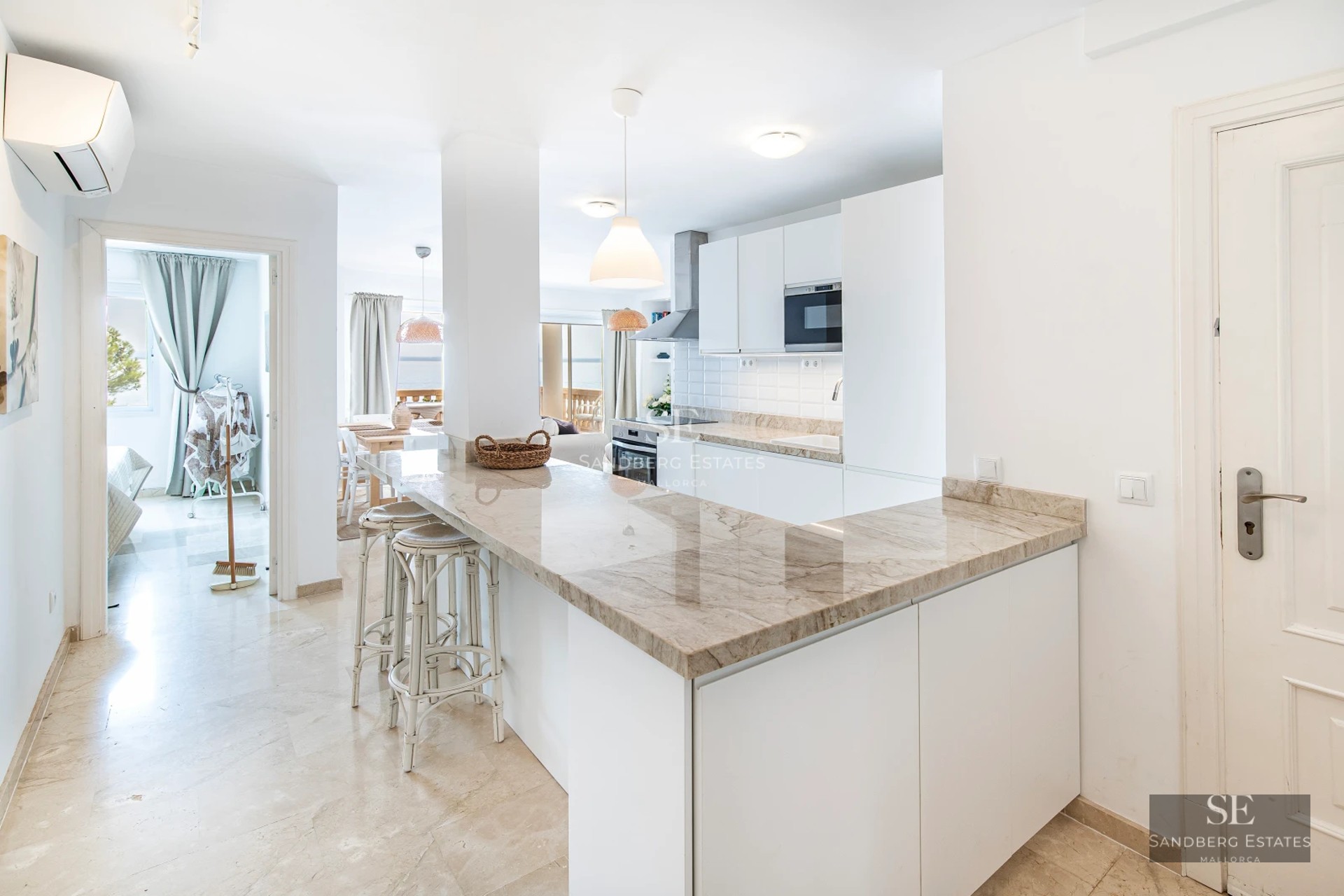 Exterior of a modern villa featuring a pool, large windows, and minimalist design. Lush landscaping and blue sky.