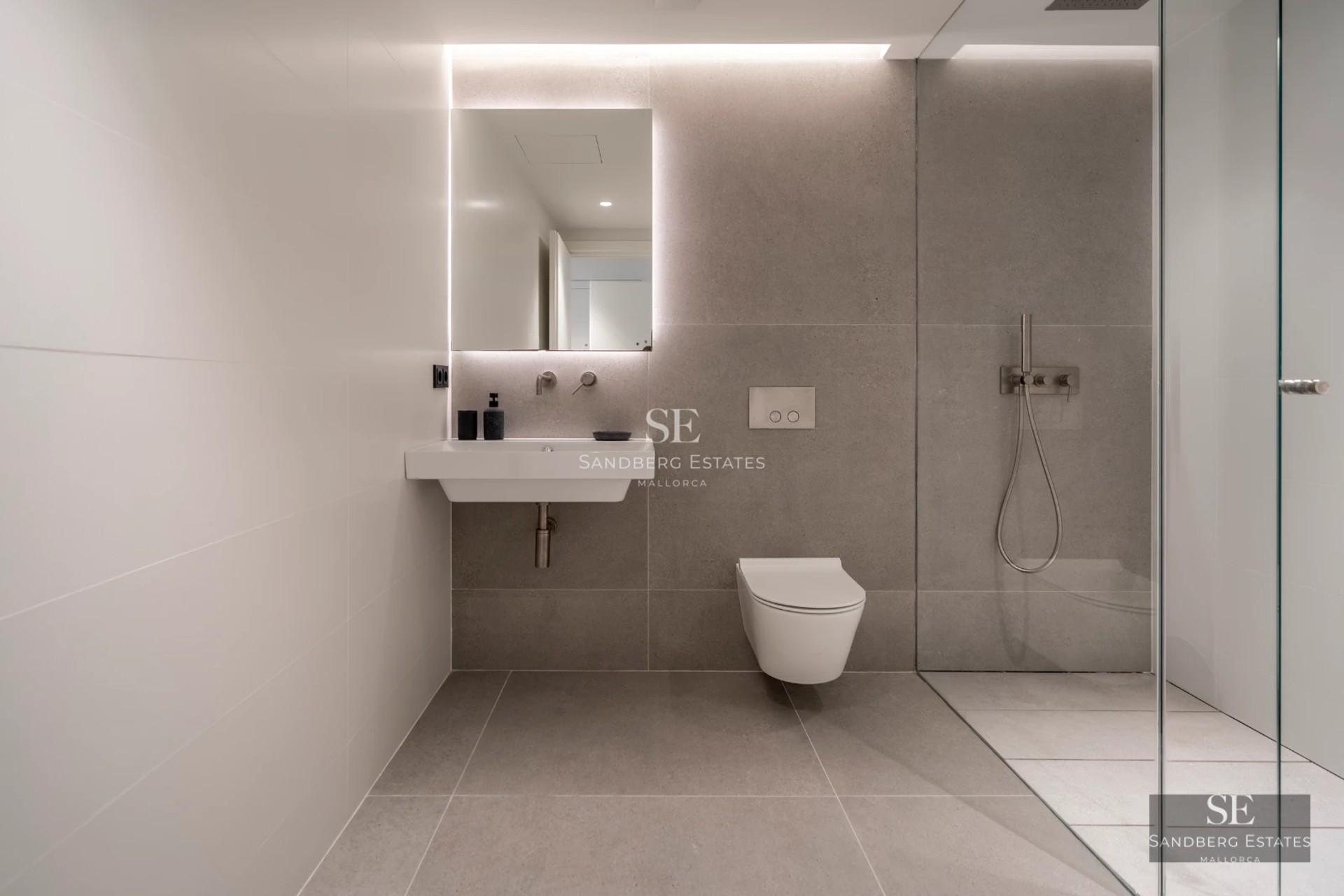 Spacious balcony with sea view. Modern furniture, wooden floor, and glass railing. Soft lighting and relaxing atmosphere.