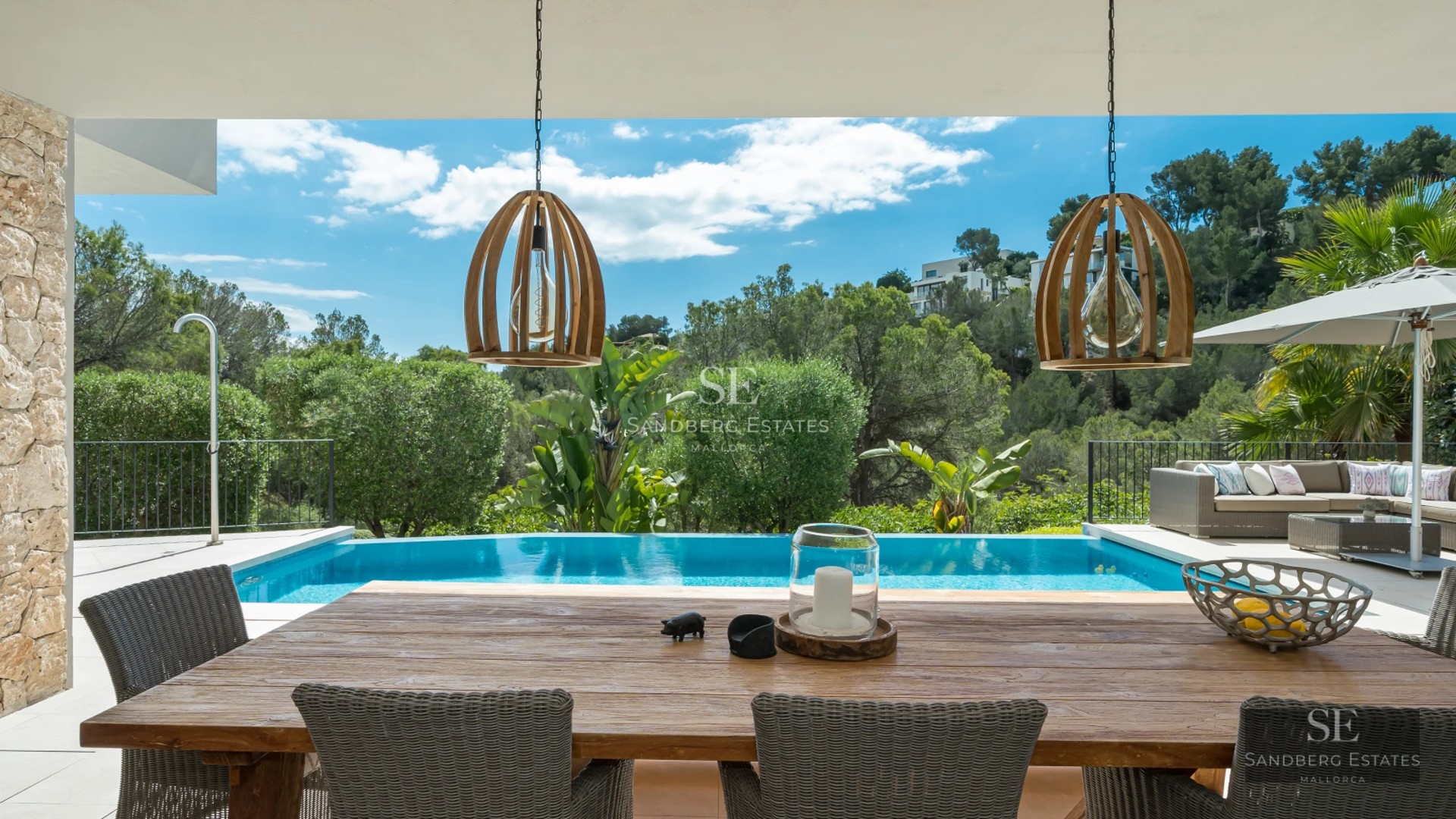 Exterior of a modern villa with a pool, outdoor living area, and lush greenery. Minimalist and elegant design.