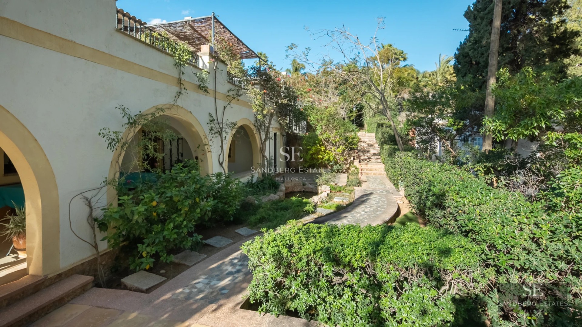 Sea view from a modern balcony with glass railing. Bright interior, minimalist design, and high-end furniture.