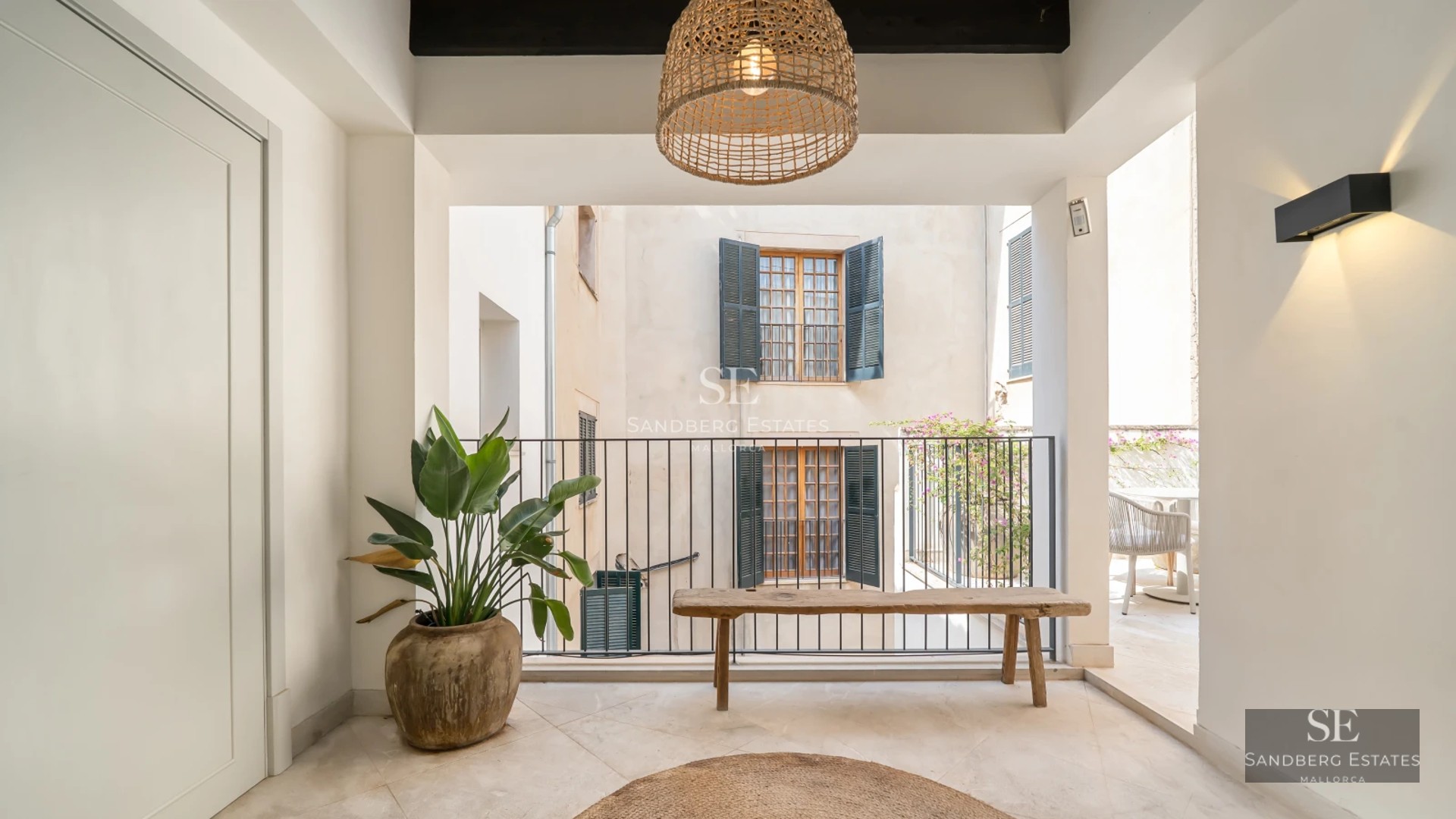 Spacious pool surrounded by a lush garden with modern furniture. House with large windows and elegant architectural design.