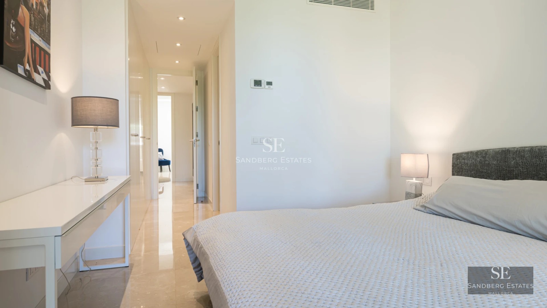 View of modern villa with reflecting pool. Minimalist design, large garden, green lawn. Sleek architecture with large windows.