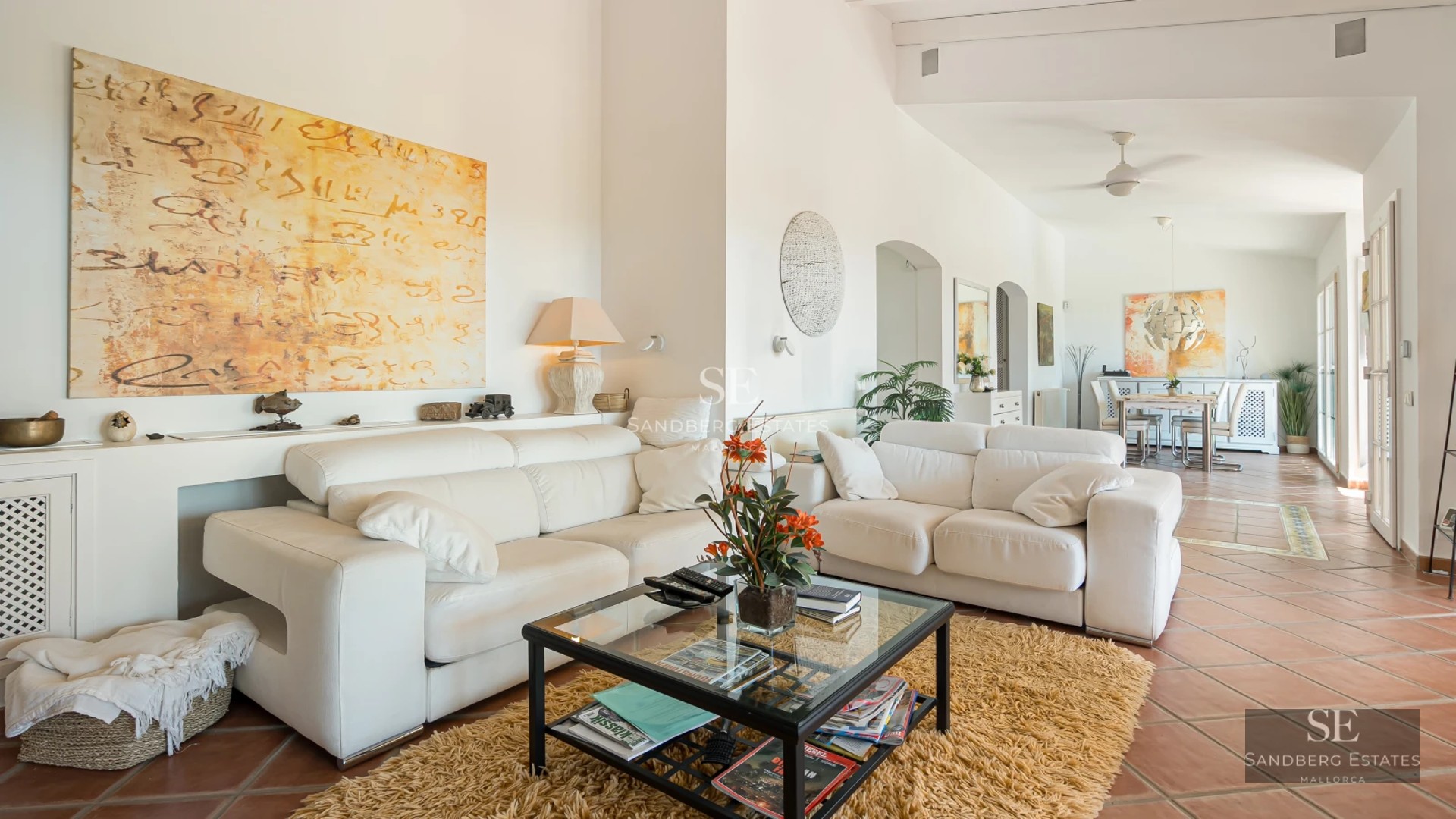 Exterior view of a modern villa featuring a pool, expansive terraces, lush gardens, and clean, minimalist architectural design.