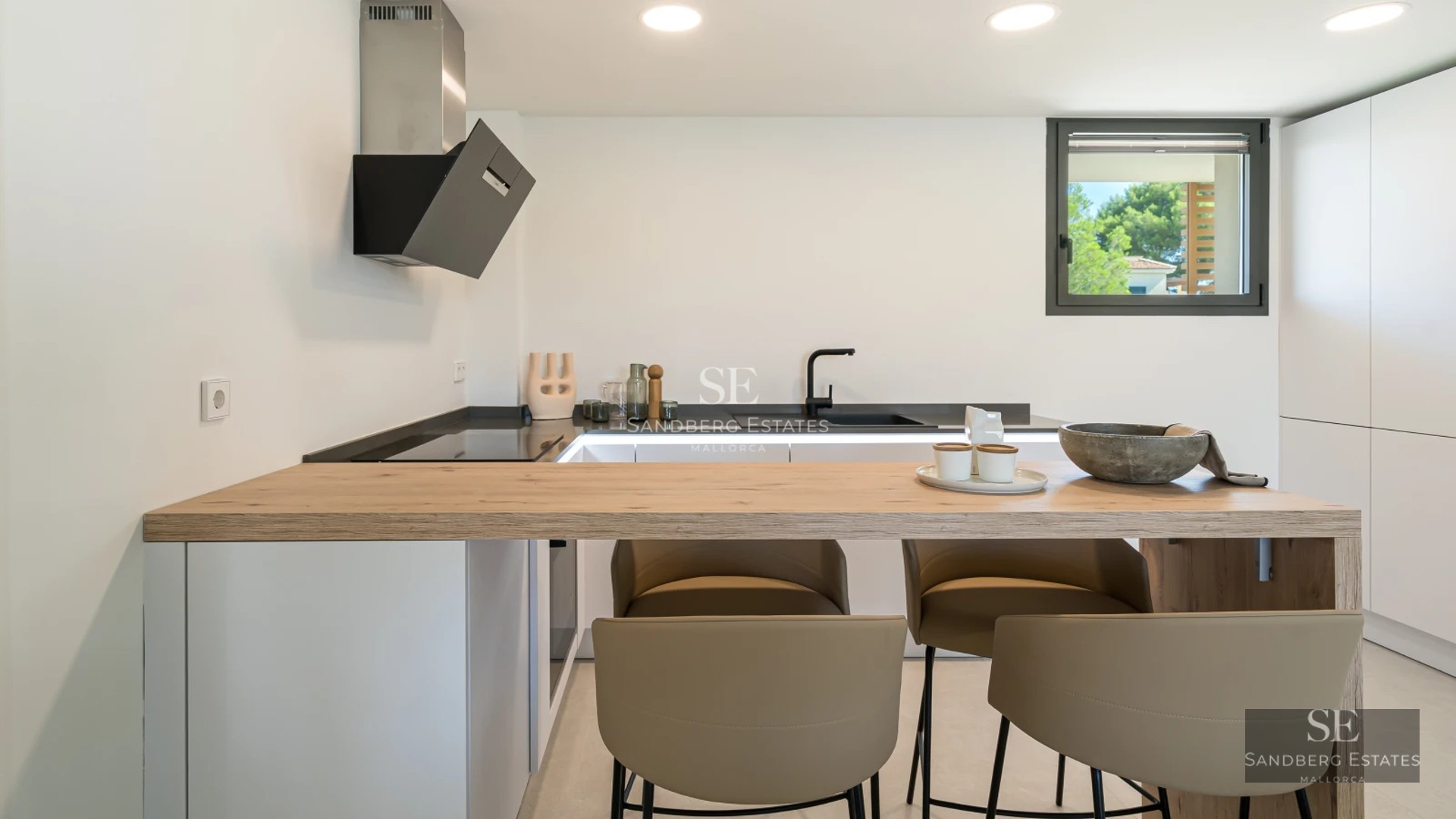 Spacious living room with large windows, sea view, modern furniture, and stylish decor.