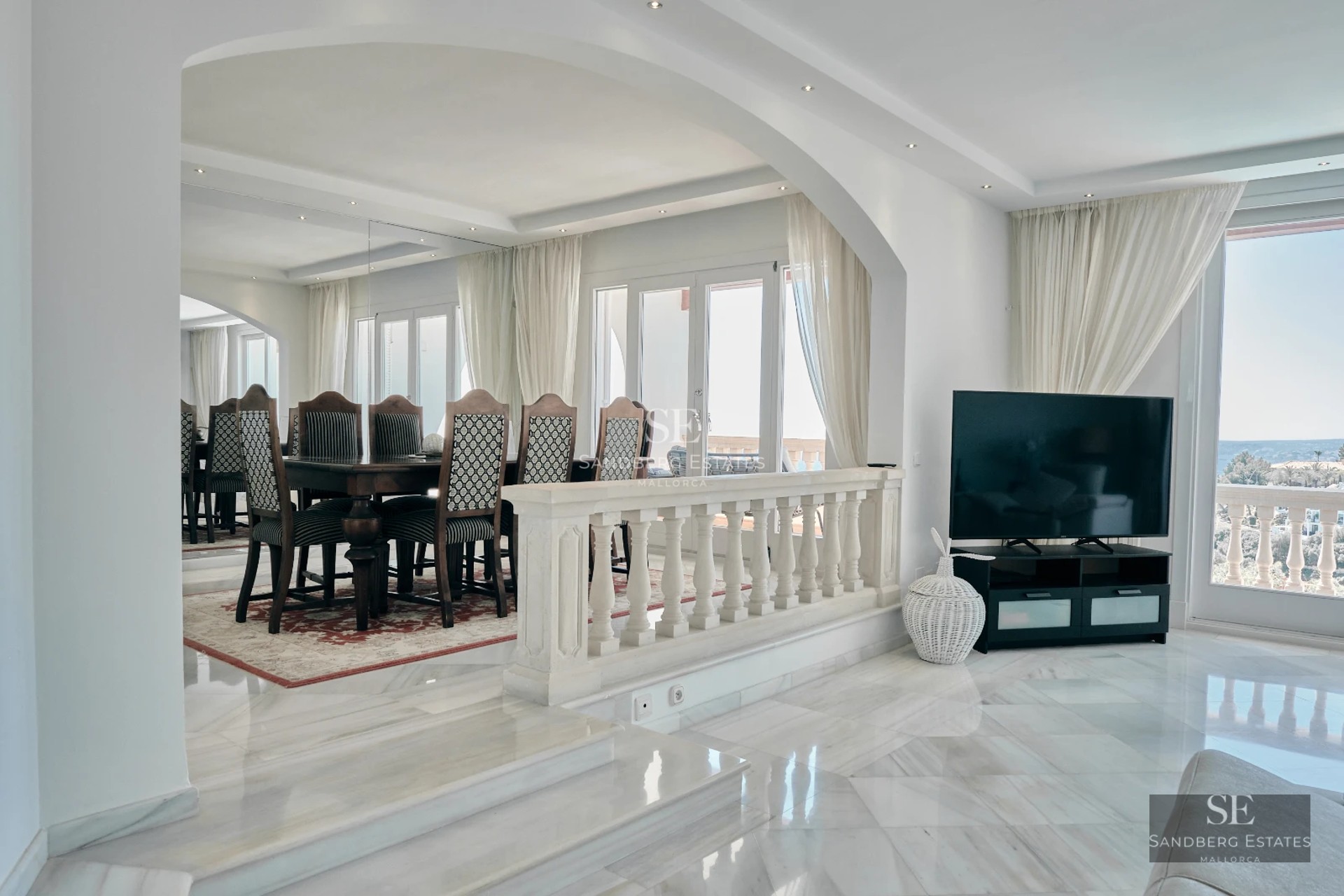 Spacious terrace featuring an infinity pool, sun loungers, and panoramic sea views. Modern design with clean lines and high-quality materials.