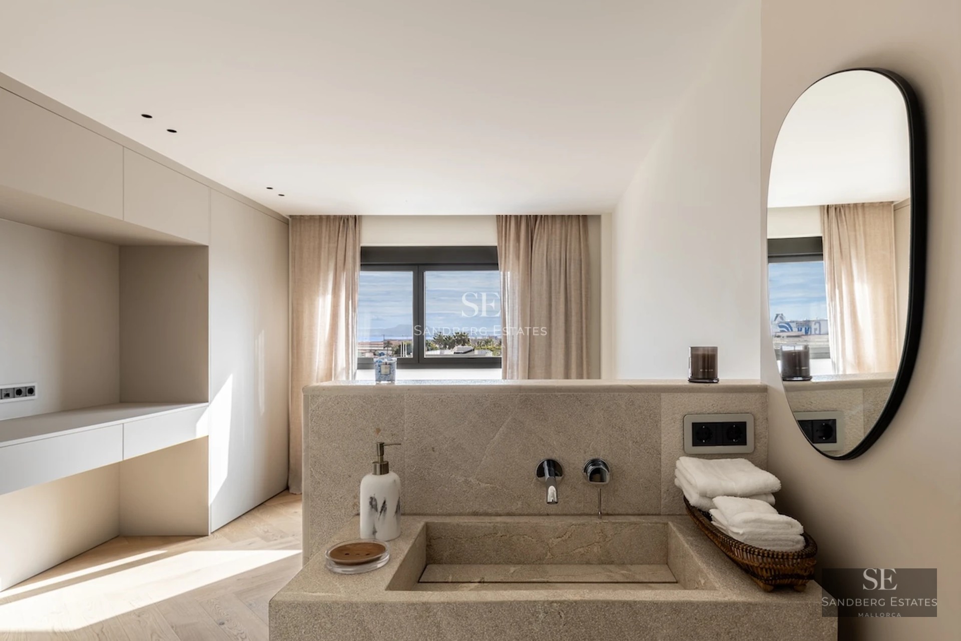 Spacious living room with floor-to-ceiling windows, panoramic sea views and terrace. Modern design, elegant furniture and abundant natural light.