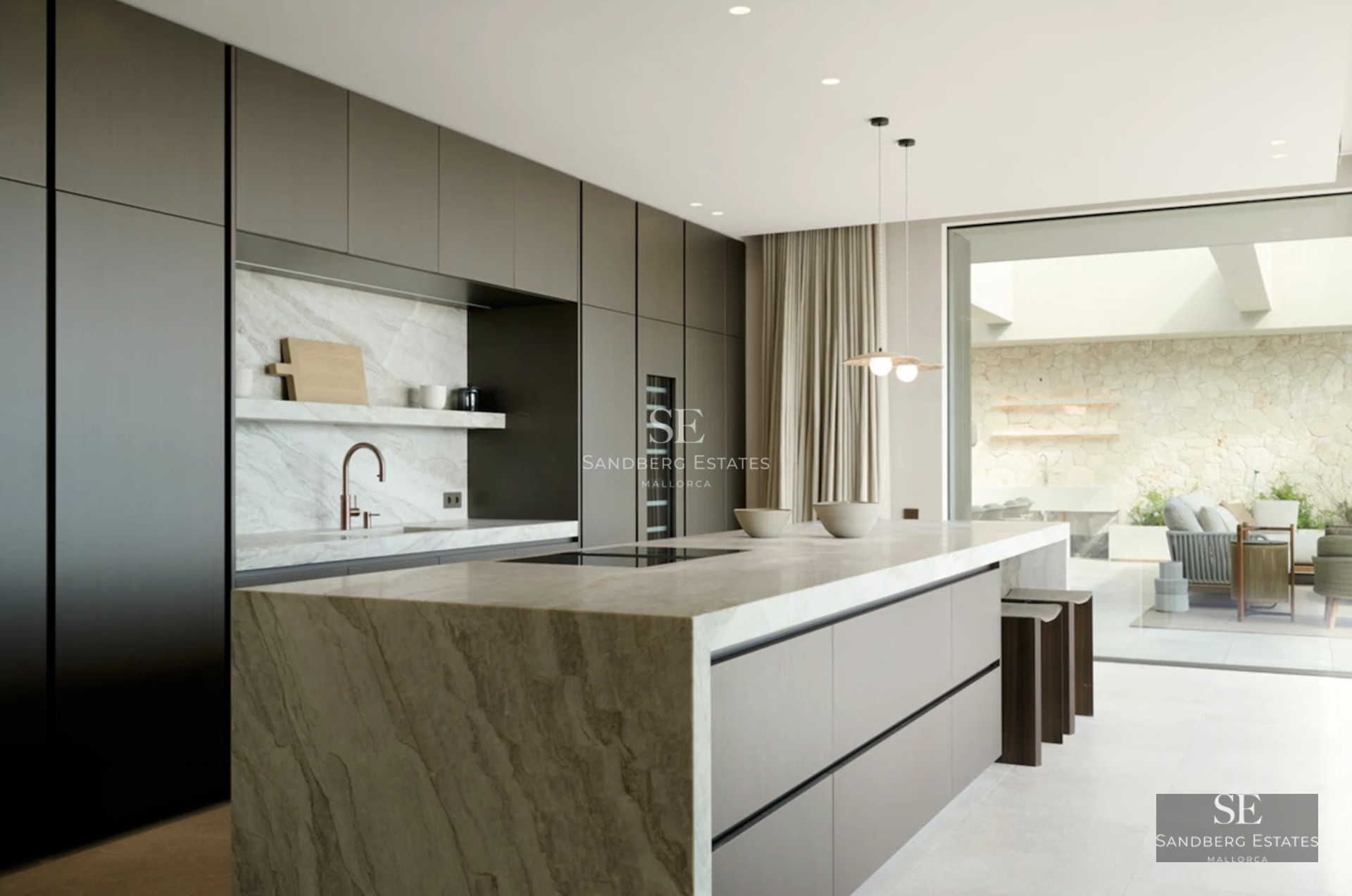 Spacious terrace with infinity pool, sun loungers, umbrellas, and panoramic sea views. Modern and elegant design.