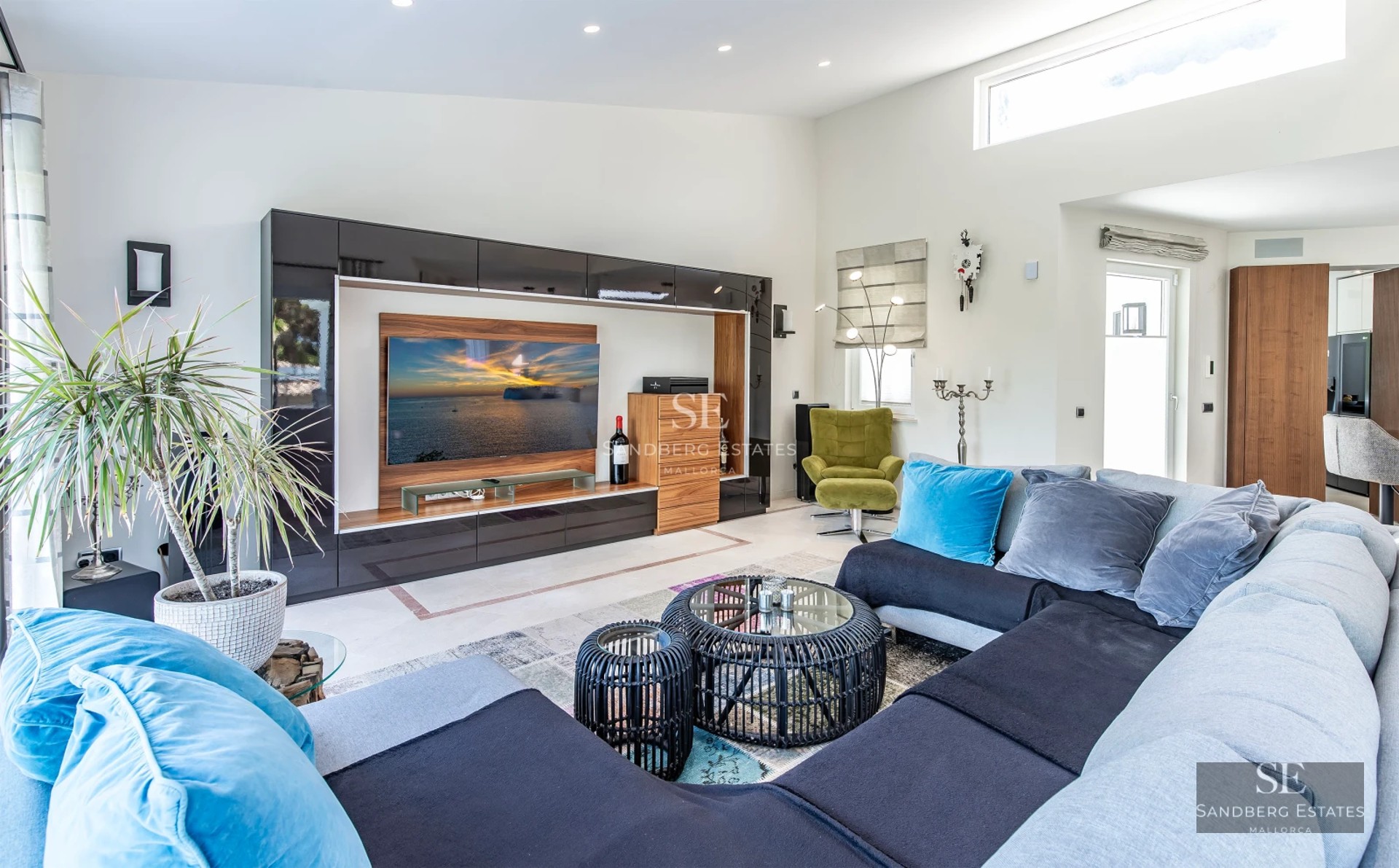 Expansive terrace with infinity pool, lounge chairs, panoramic views, and modern architecture featuring large windows.