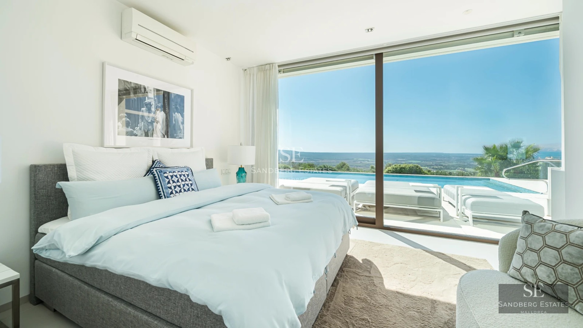 Spacious terrace with infinity pool, sun loungers, and panoramic views. Modern, elegant design with high-end outdoor furniture.