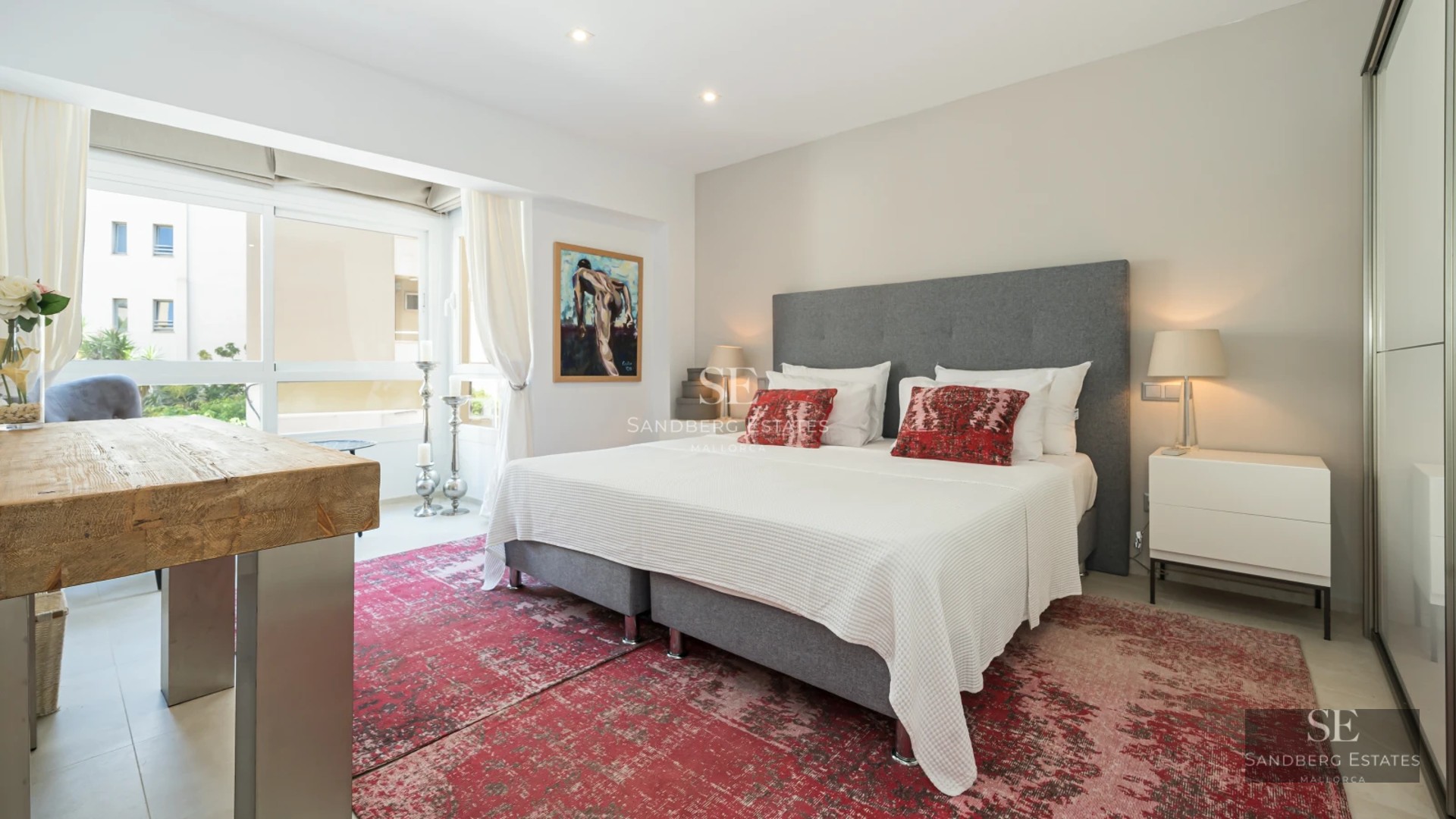 Bright living room with large windows and panoramic sea views. Modern furniture, light wood floors and minimalist decor.