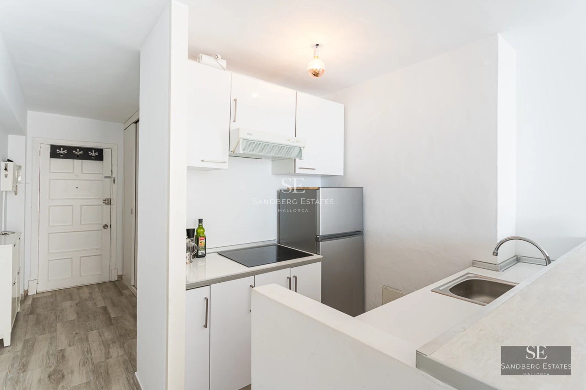 Spacious balcony with sea view. Glass railing, wooden floor and modern furniture create an elegant and relaxing space.