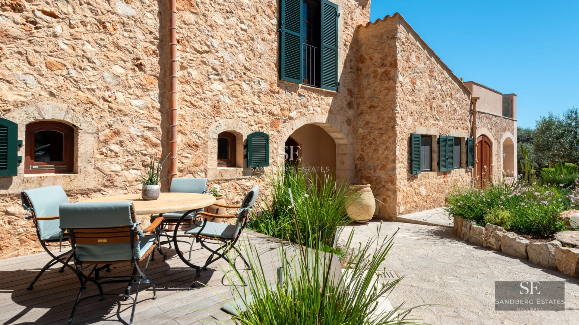 Exterior view of a modern villa with pool, large windows, and minimalist design. Well-manicured garden. Ambient lighting.