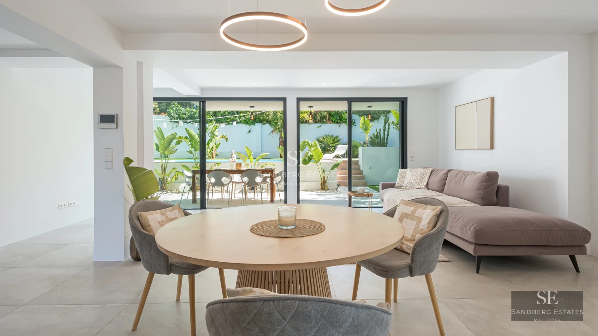 Spacious terrace with infinity pool, modern furniture, and panoramic views. Elegant and minimalist architectural design.