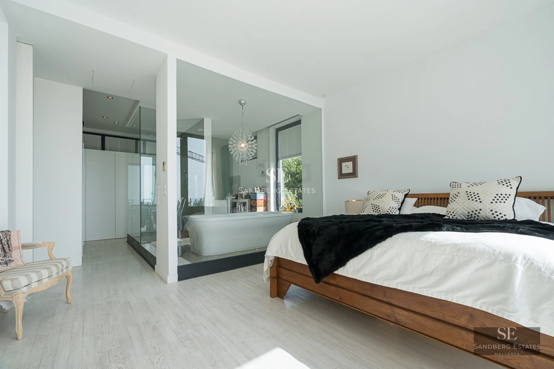 Exterior view of modern villa featuring an infinity pool, landscaped garden, and minimalist architecture. Soft sunset lighting.