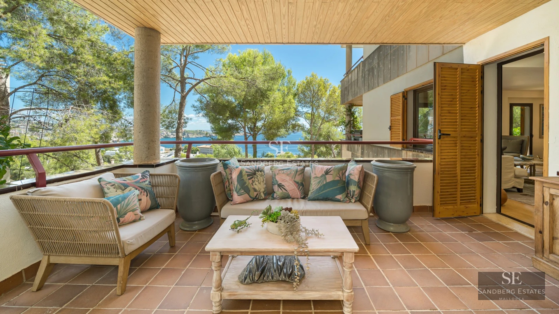 Interior view of a bright apartment with large windows, light wood floors, and modern furnishings. Minimalist and elegant design.