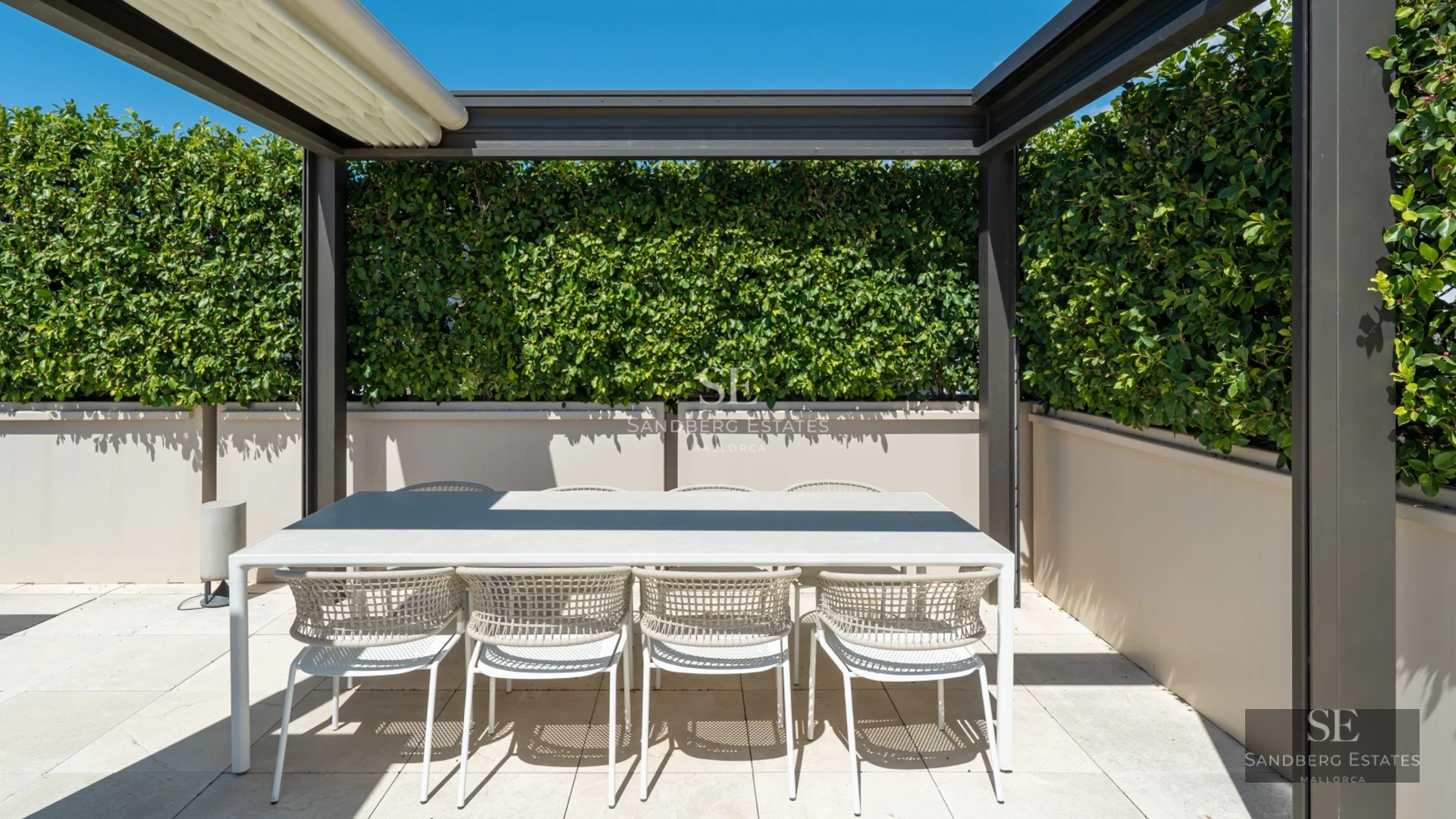 Expansive terrace featuring an infinity pool, sun loungers, and panoramic ocean views. Sleek and modern design.