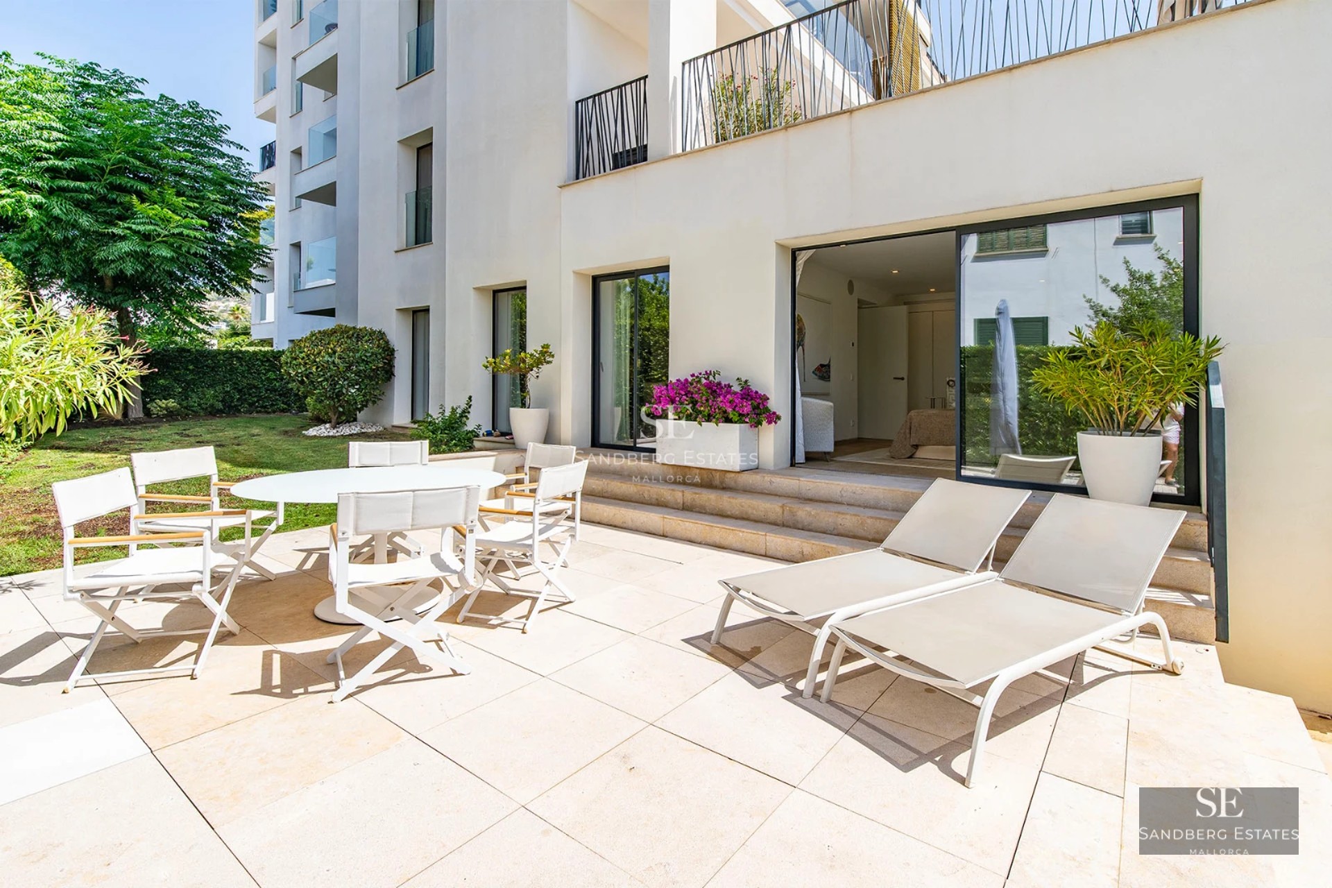 Exterior view of a modern villa featuring an infinity pool and lush garden. Minimalist architecture, large windows, and landscaped grounds.