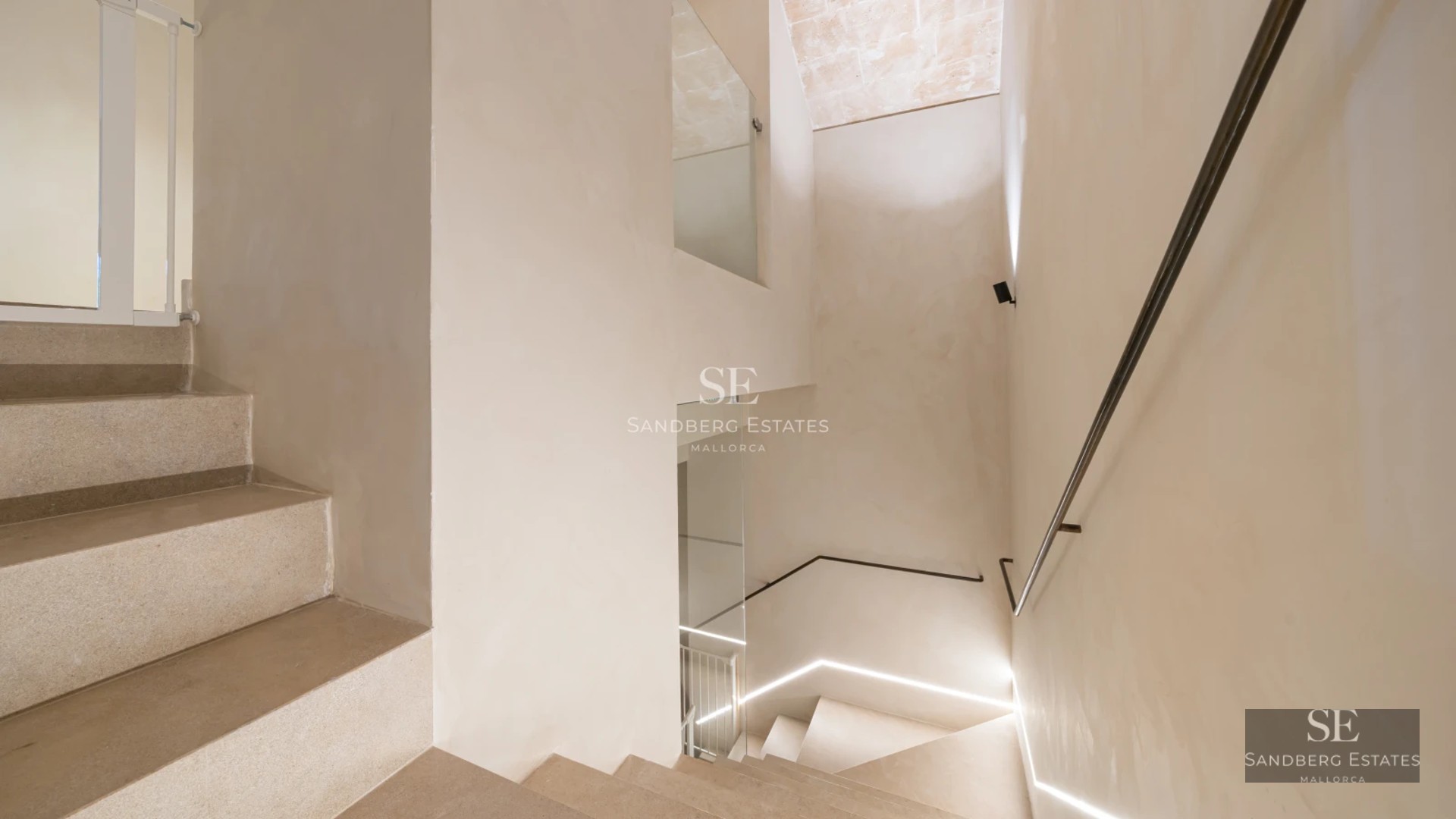 View of modern villa with pool and lush garden. Large windows and minimalist design highlight the natural light.