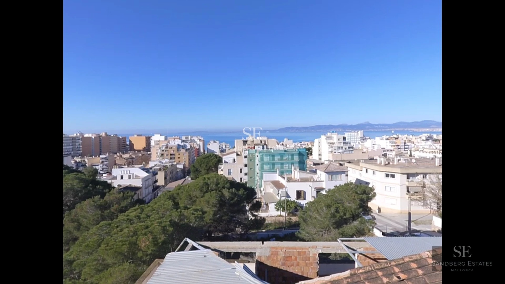 View of living room featuring a fireplace, large windows and modern design. Minimalist decor with neutral colors and abundant natural light.