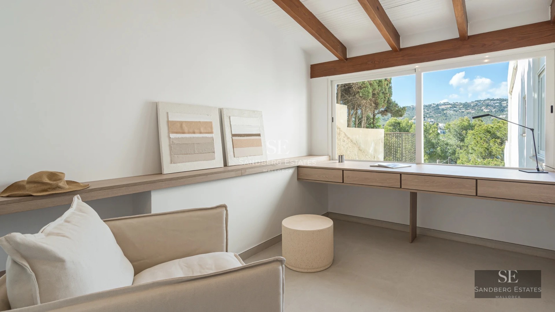 Spacious sea view balcony with modern design, glass railing. Light wood flooring and elegant outdoor furniture.