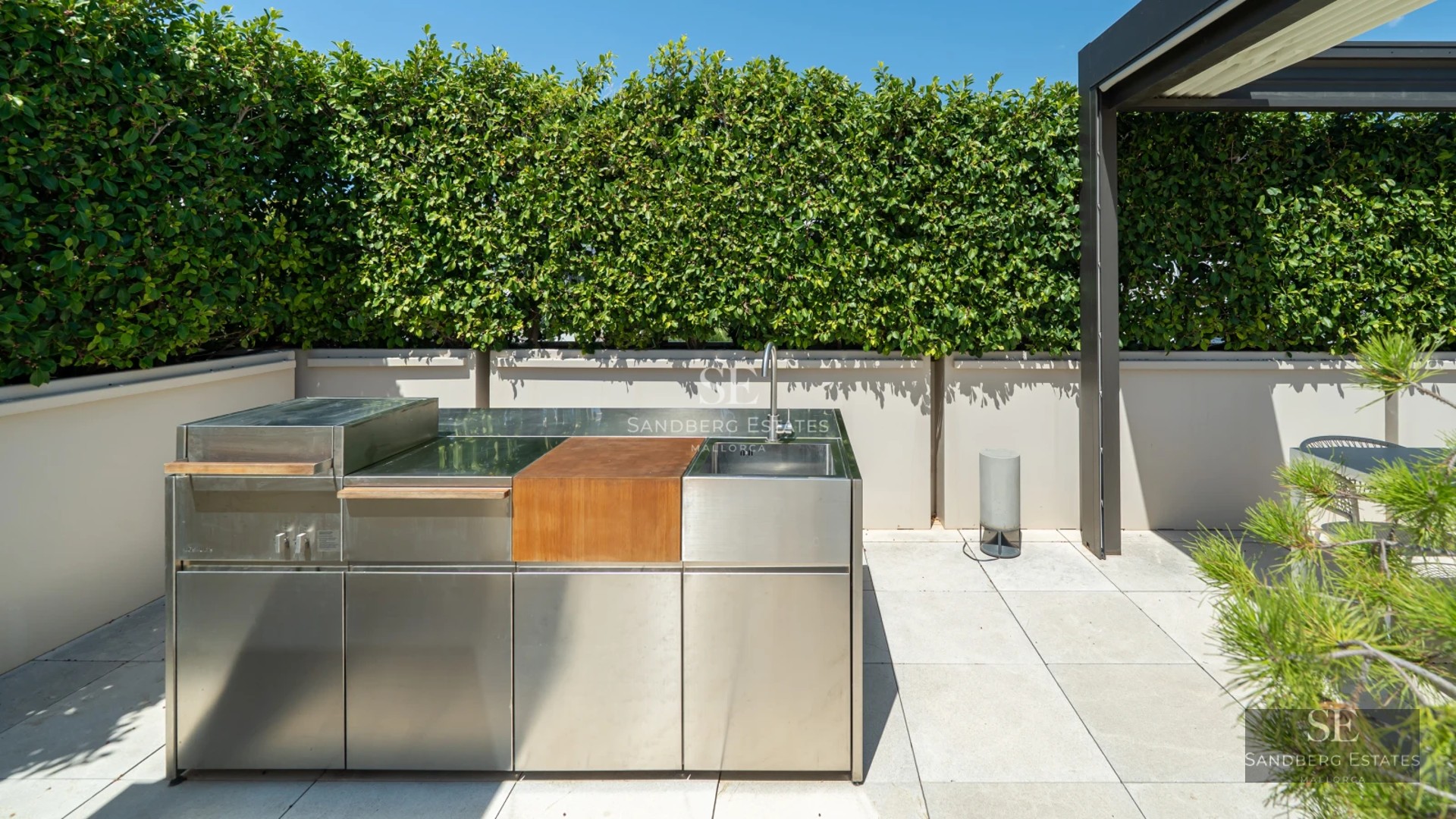 Panoramic view of a modern living room with glazed balcony and sea view. Minimalist design, neutral colors and abundant natural light.