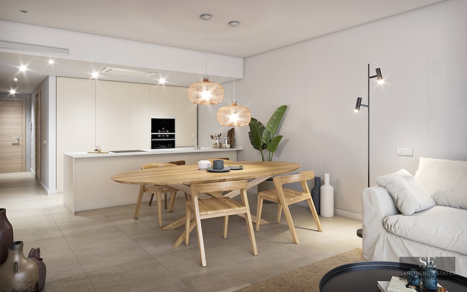 Modern dining area featuring an oval wooden table, wicker pendant lights, and a minimalist integrated kitchen.