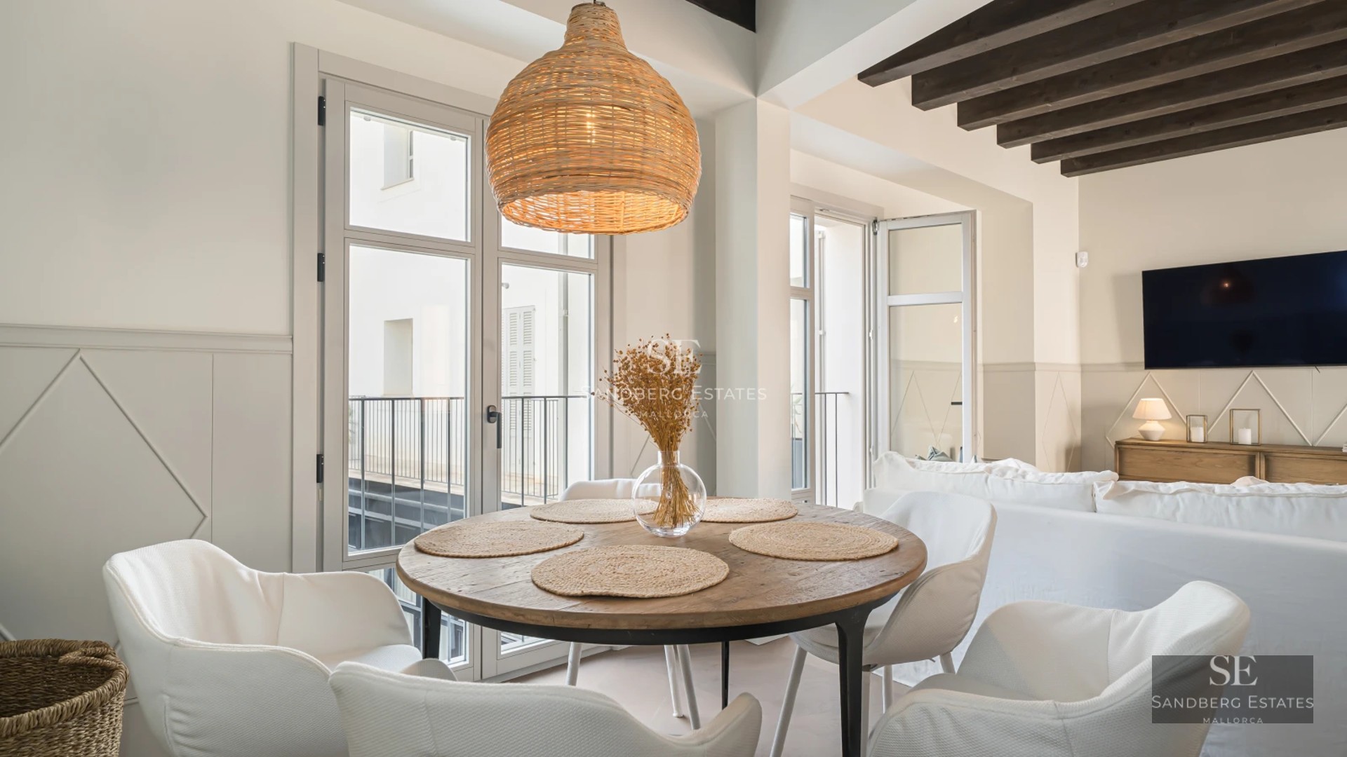 Modern interior featuring a large living room, expansive windows, natural light, and elegant furnishings. Panoramic views.