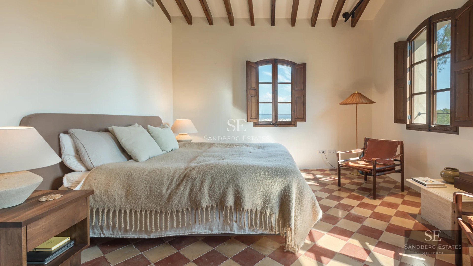 Spacious balcony with sea view. Minimalist design with modern furniture. Glass railing offering panoramic views. Natural lighting.