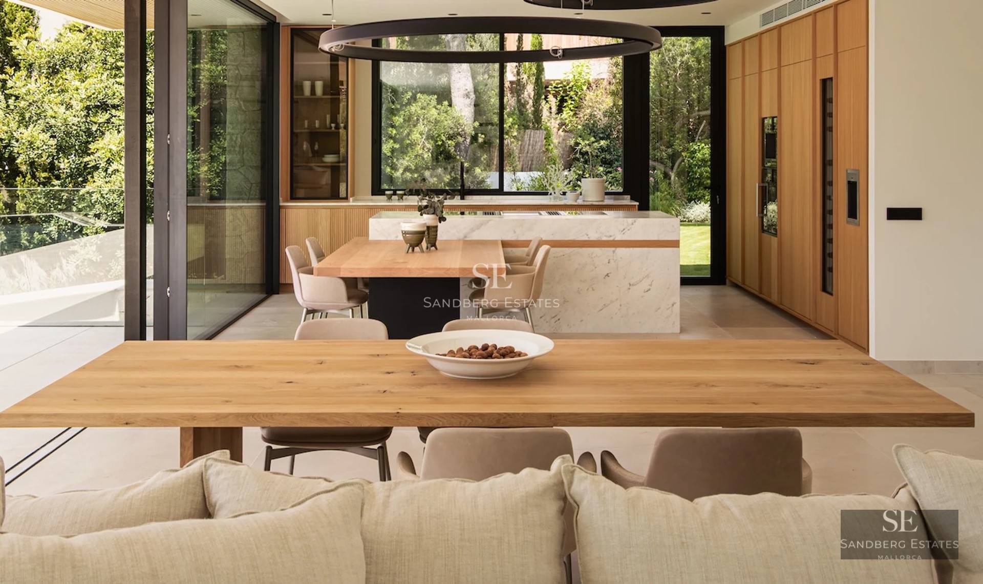 Spacious balcony with panoramic sea views. Modern design, glass railing, tiled floor, and stylish furniture.