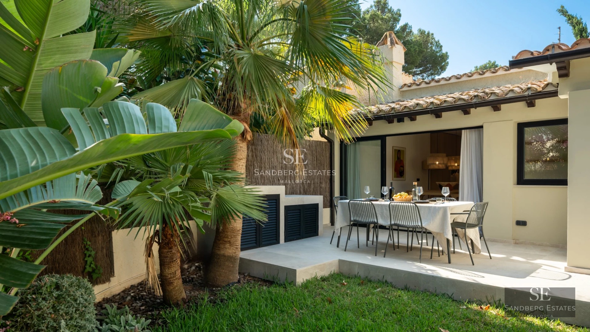 Spacious living room with large windows, light wood floors, and modern design. Abundant natural light and terrace access.