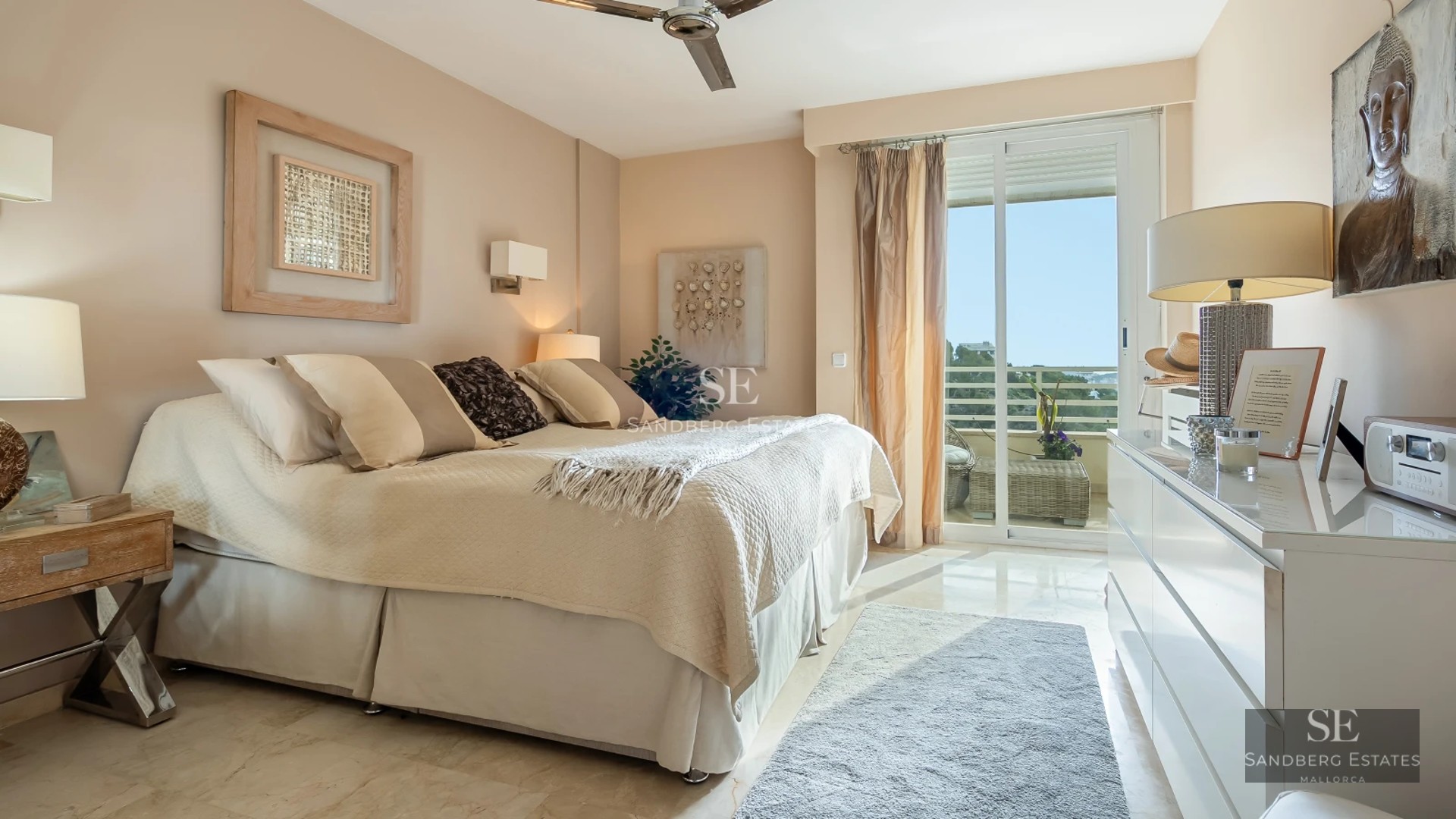 Spacious balcony overlooking the sea, modern designer furniture, wooden floor and glass railing. Luxury and exclusivity.