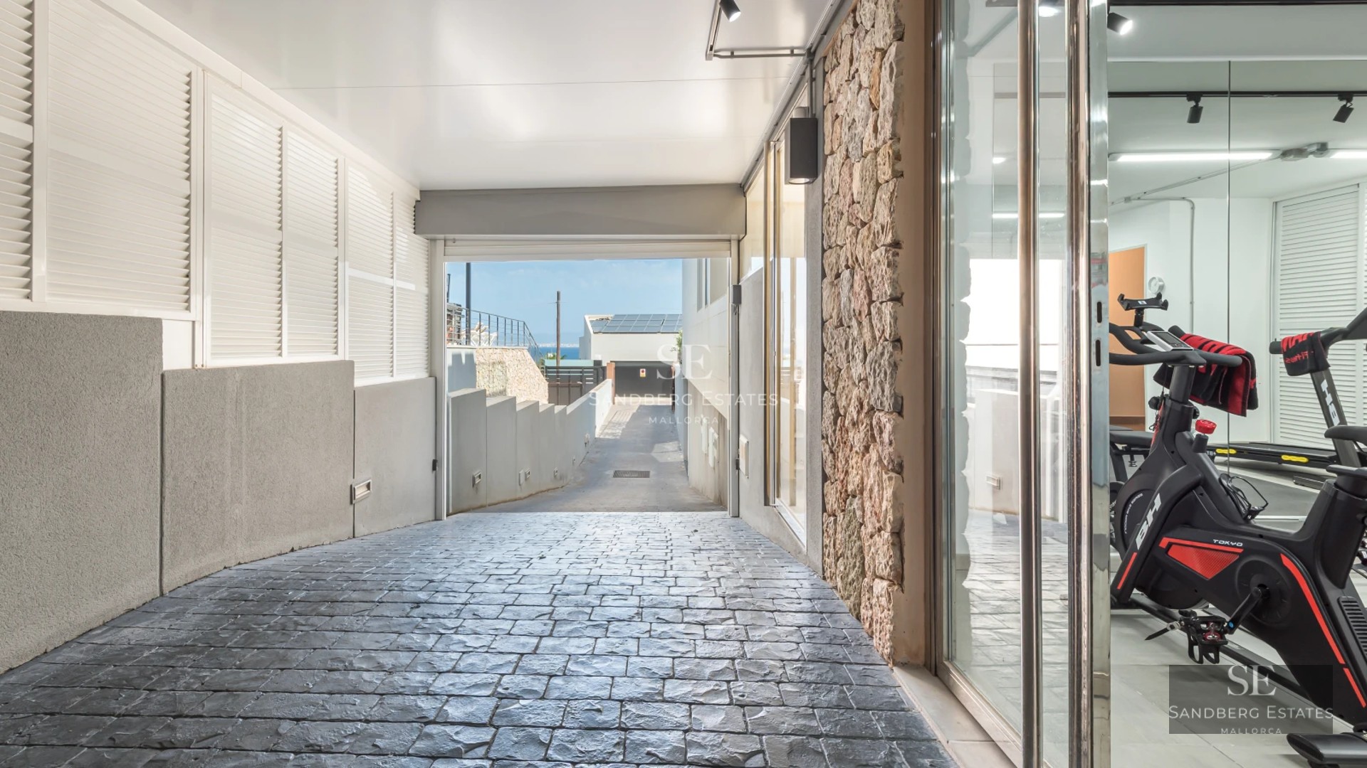 View of infinity pool surrounded by greenery. Modern outdoor furniture and elegant architectural design.