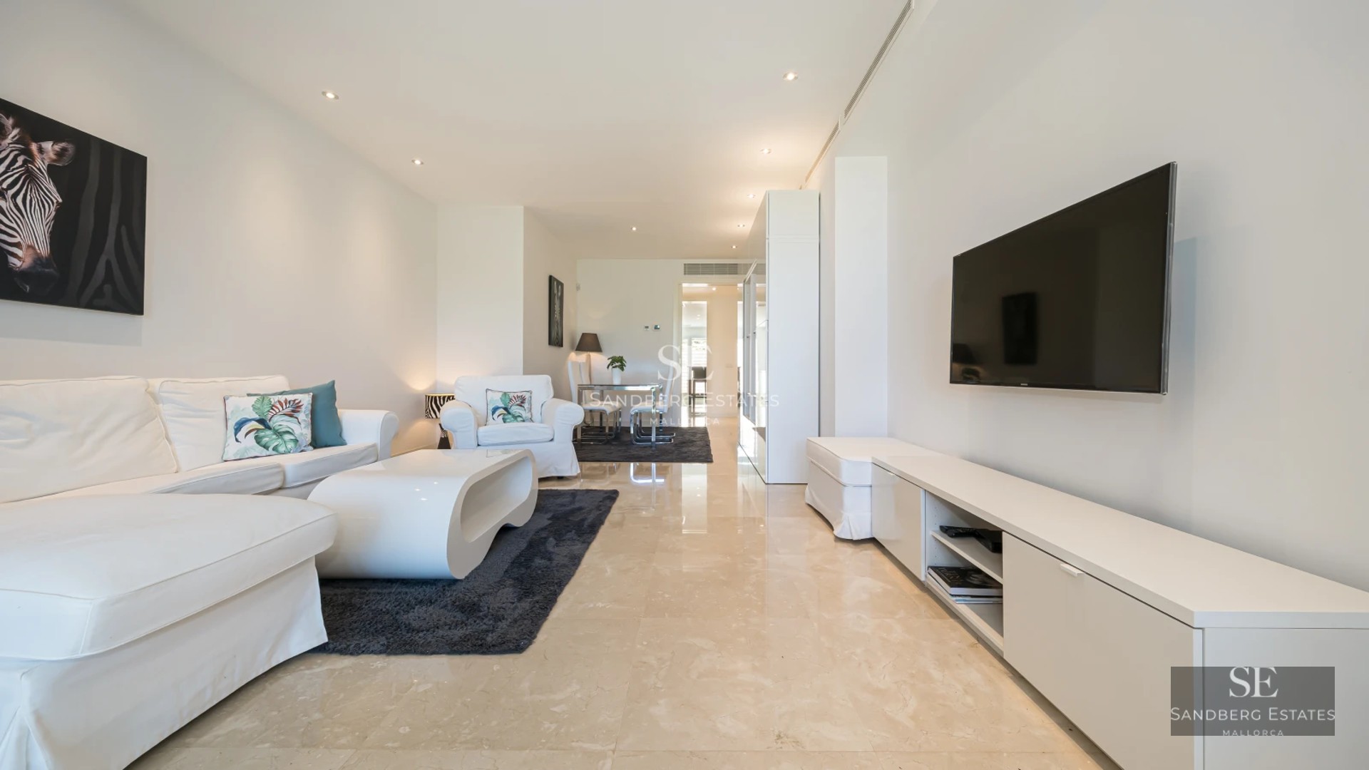 Expansive terrace featuring an infinity pool, elegant outdoor furniture, panoramic sea views, and minimalist architecture.