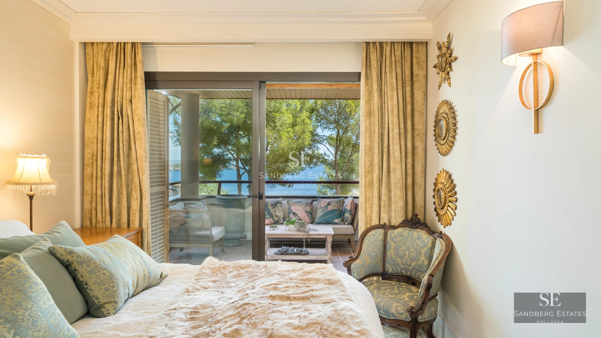 Spacious balcony with sea views. Modern design with glass railings, tiled floor and elegant furniture.