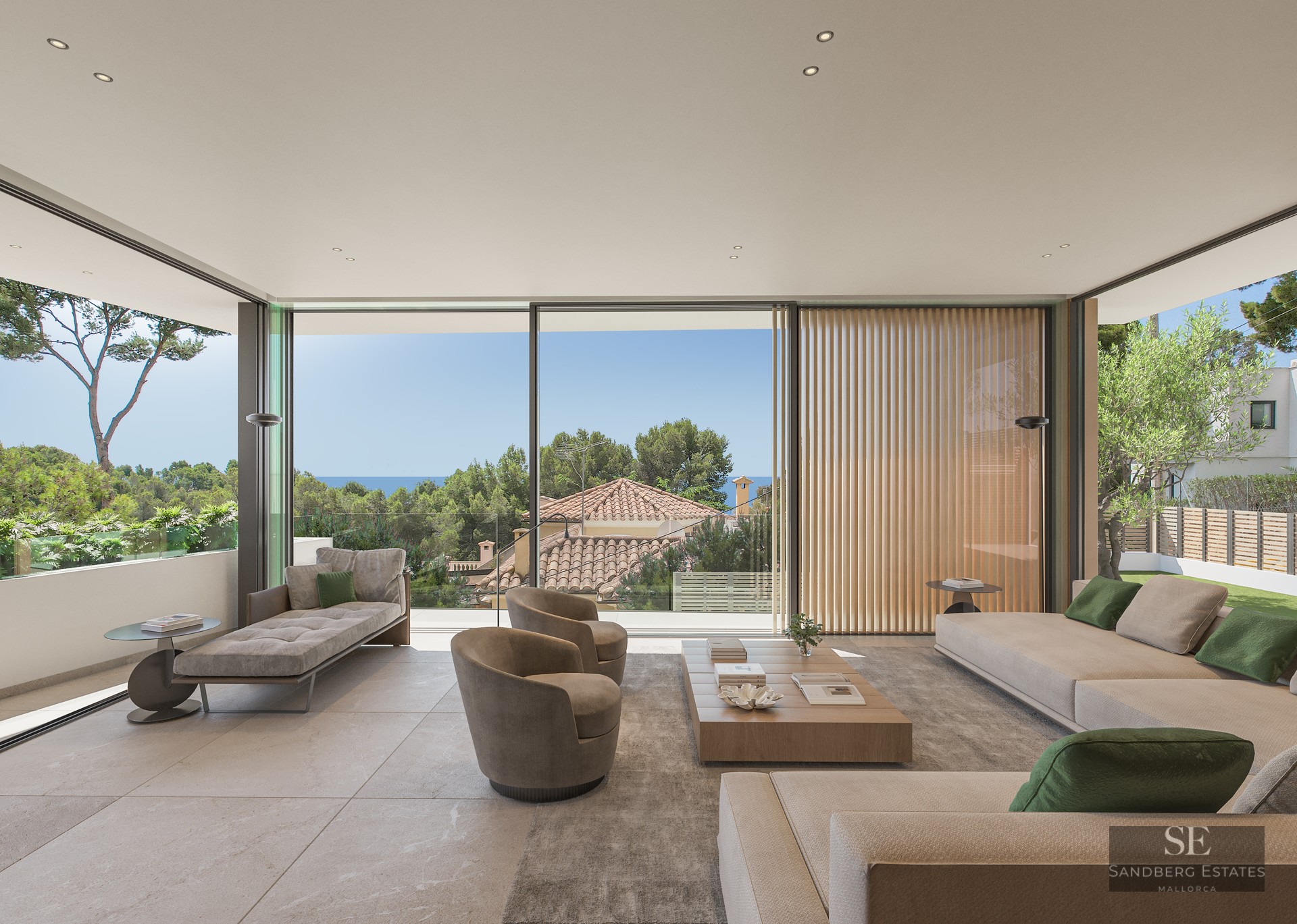 Modern living room with floor-to-ceiling glass walls, beige sofas, wood table, and views of trees and the sea.