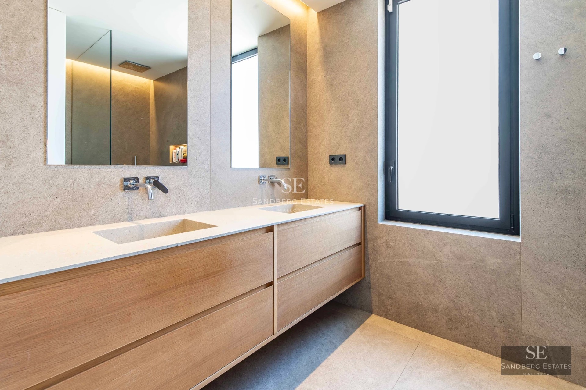 Spacious balcony with sea views. Glass railing, modern furniture, and wooden flooring. Minimalist design and abundant natural light.