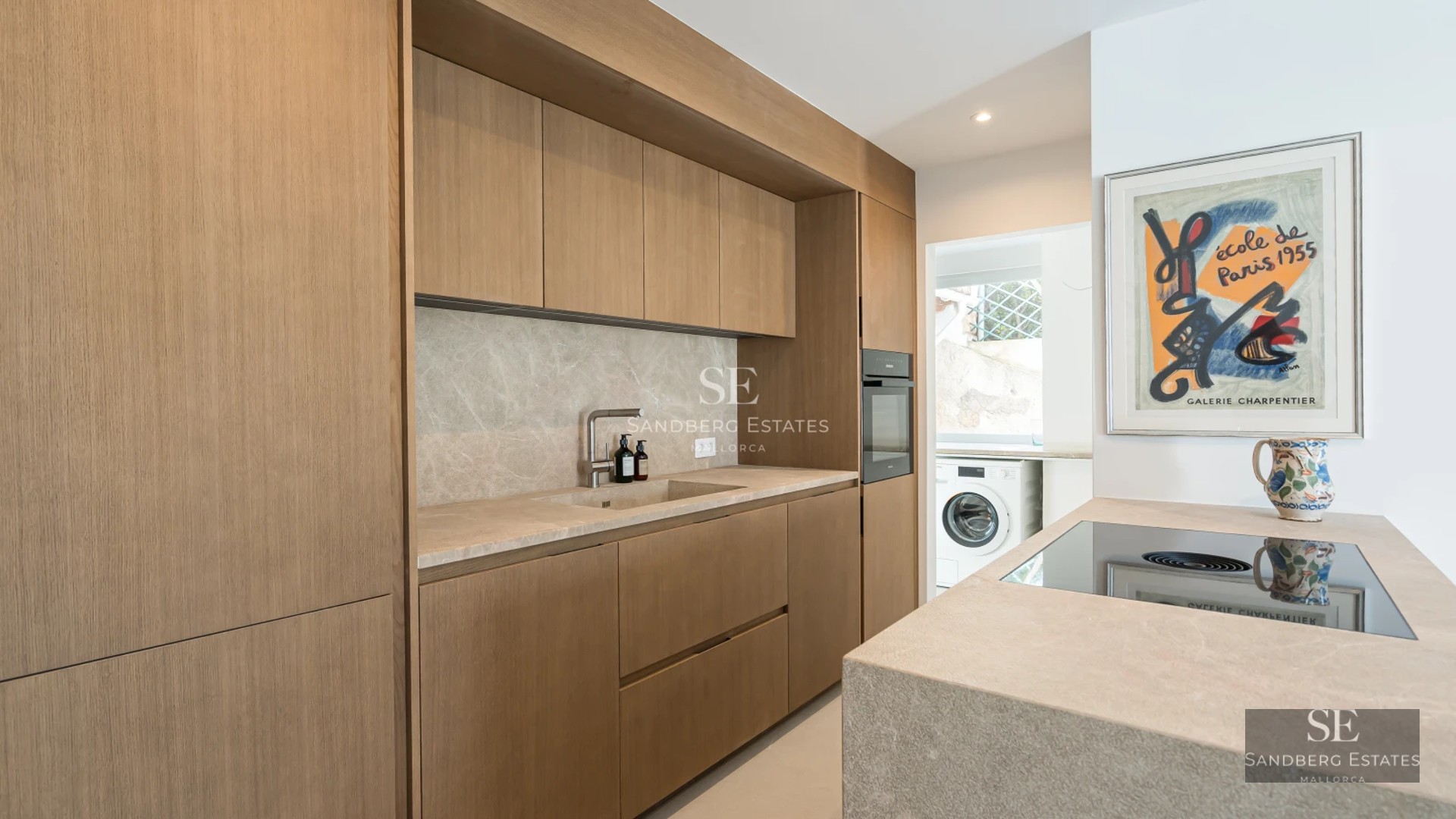 Bright living room with outdoor pool, large windows, minimalist decor, light wood floors, and contemporary designer furniture.