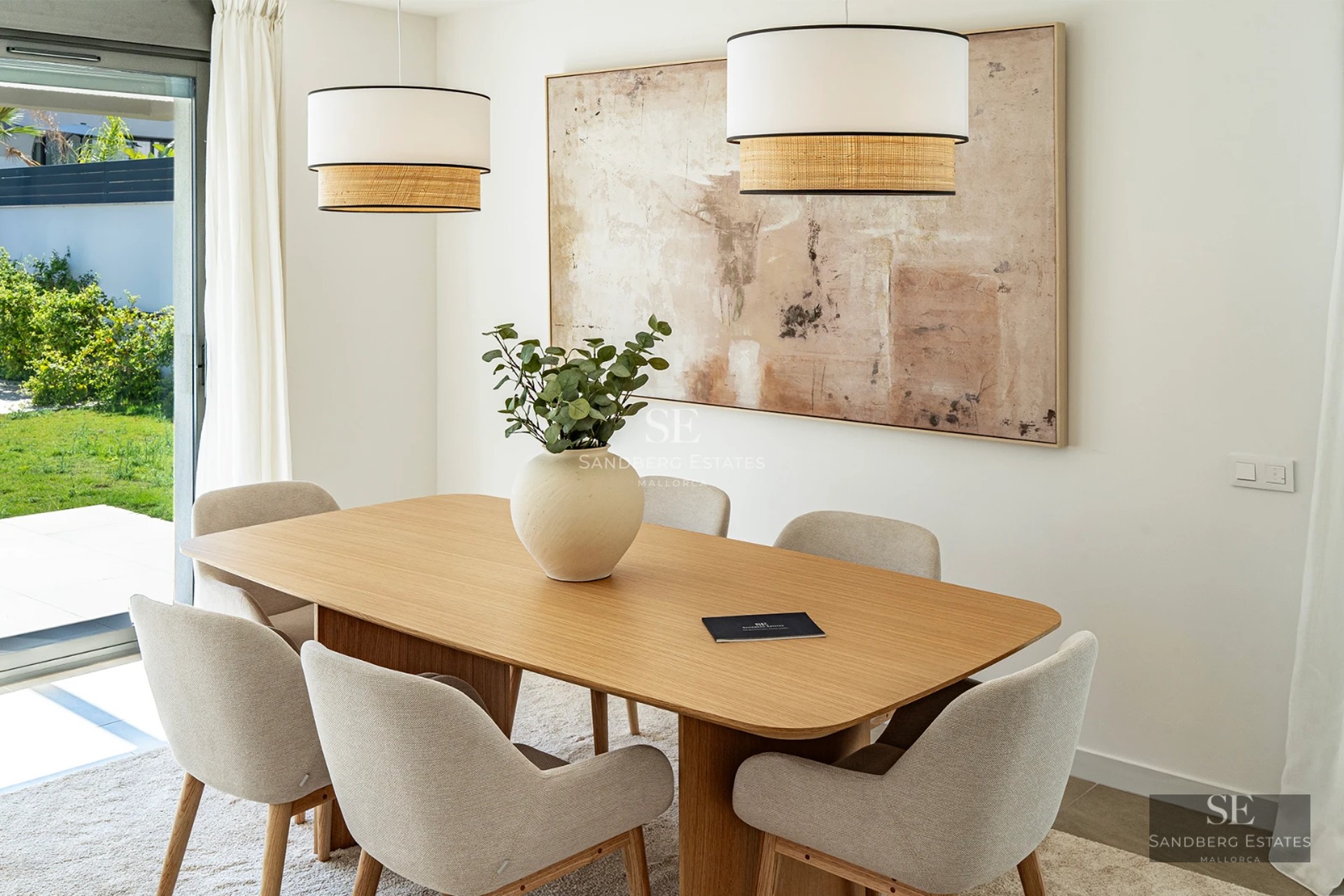 Exterior view of a modern villa featuring a pool, garden, and large windows providing ample natural light.