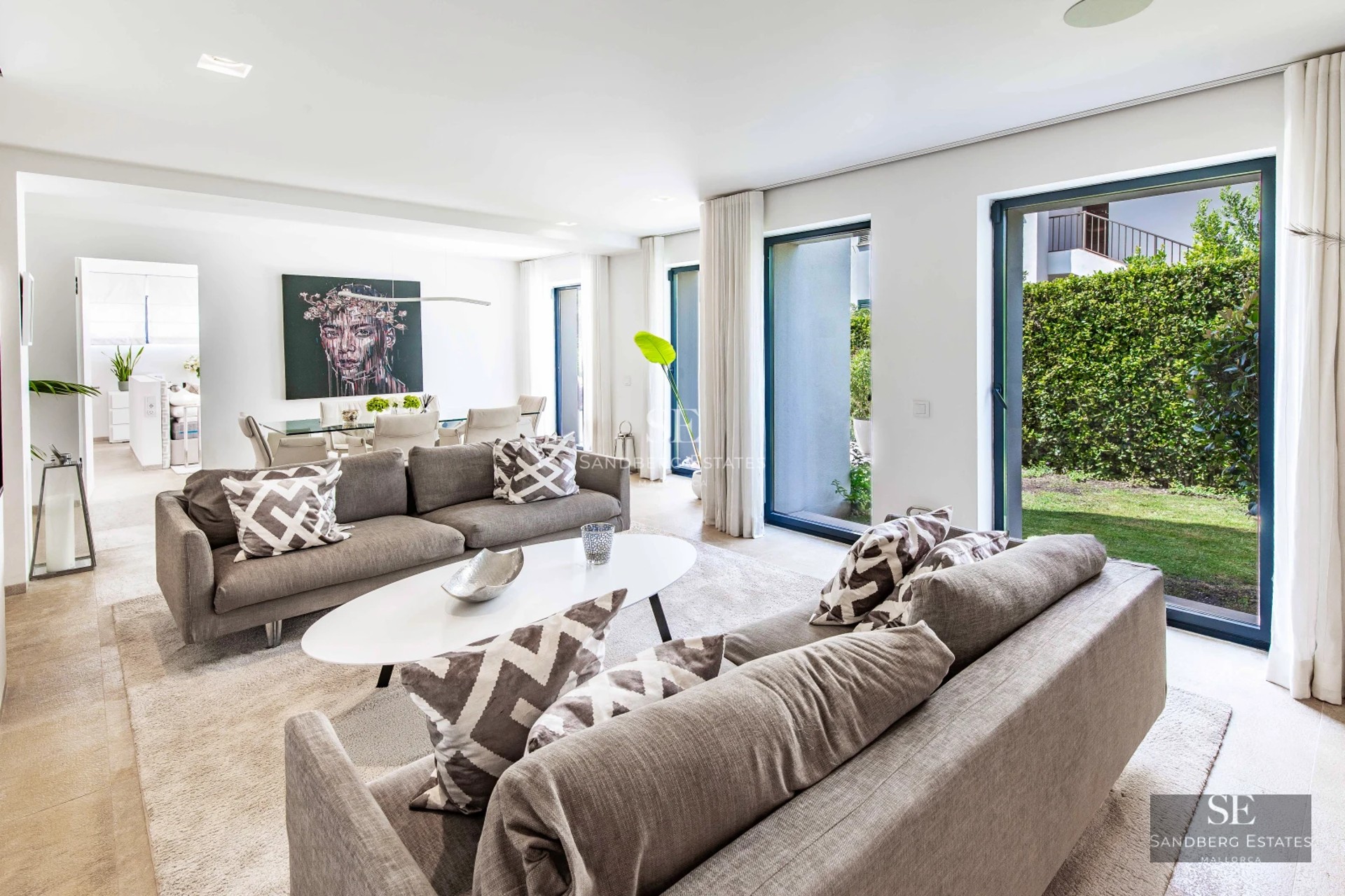 View of modern villa with infinity pool, expansive terraces and lush garden. Minimalist architectural design with natural light.