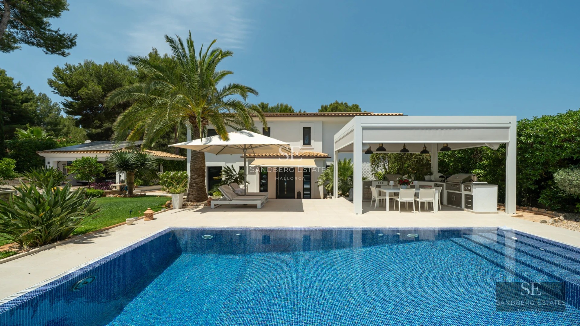 View of infinity pool, sun deck, and minimalist modern architecture. Stone details, glass, and expansive terraces.