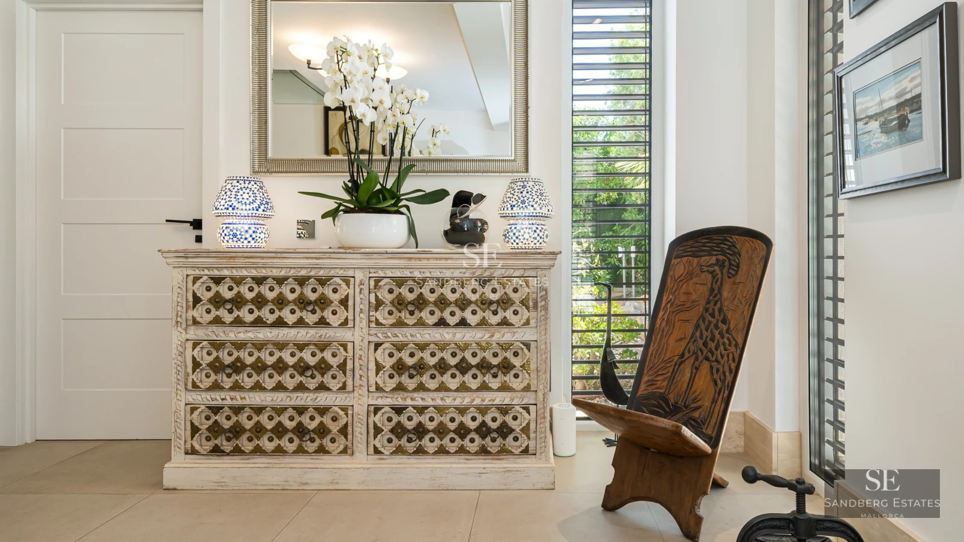 View of a luxurious villa with a pool, garden, and modern architecture. Large windows and elegant design.