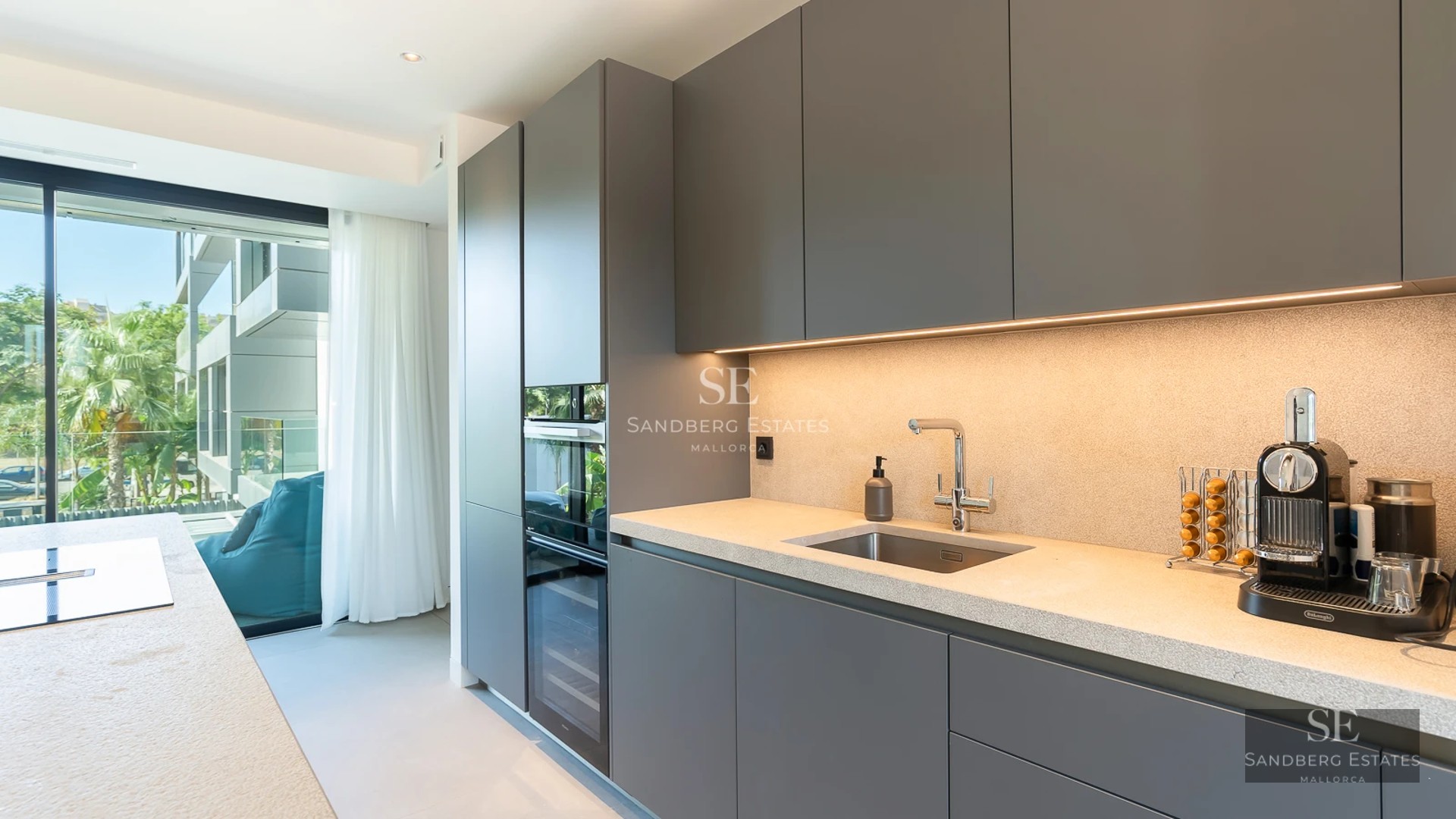 View of infinity pool with modern design, surrounded by gardens and panoramic sea views. Spacious terraces and minimalist architecture.