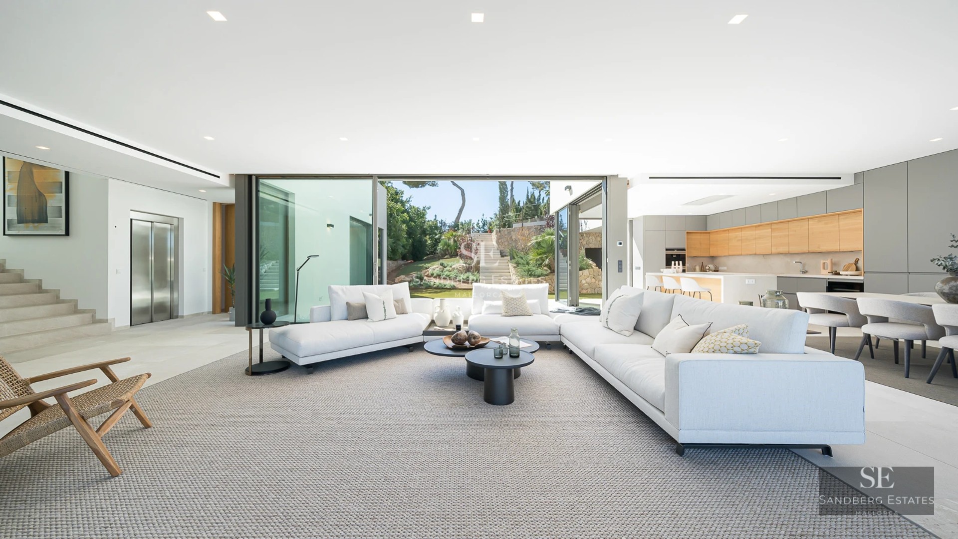 Aerial view of a modern villa with infinity pool, surrounded by gardens and spacious terraces. Minimalist and elegant architecture.