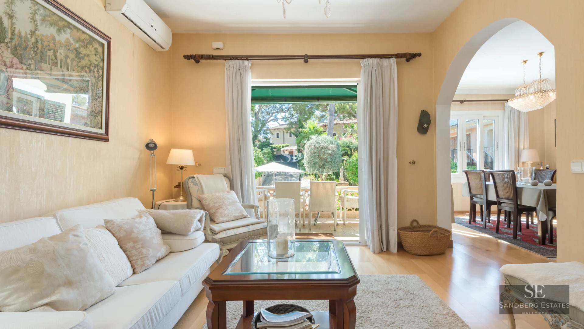 Exterior view of a modern villa featuring an infinity pool, expansive terraces, and lush gardens. Minimalist architecture with large windows.