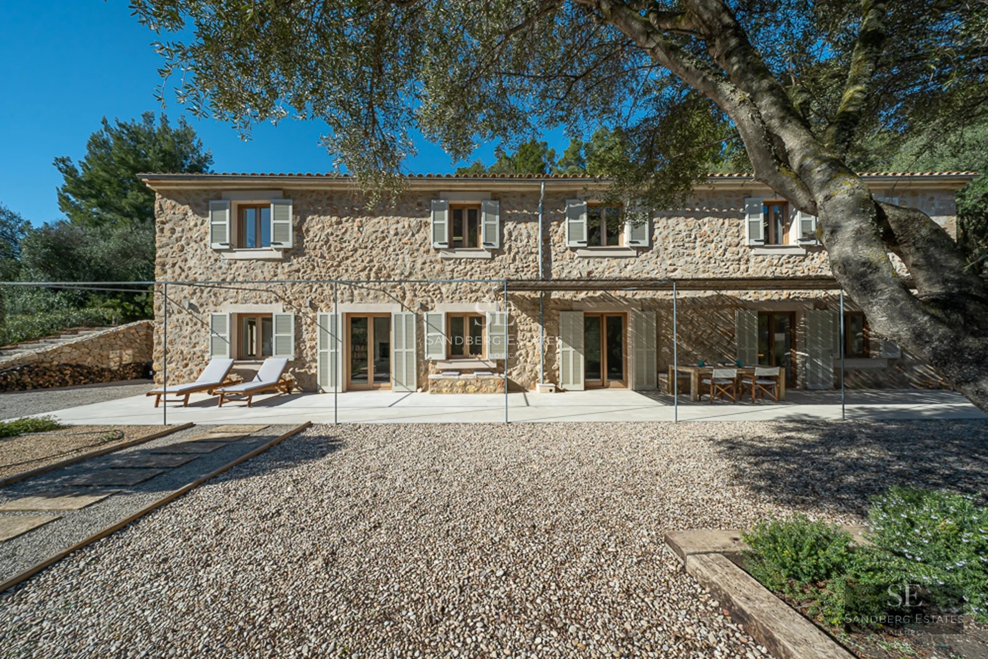 Spacious terrace with pool and seating area. Modern, minimalist architecture. Garden views. Ideal for relaxation and entertainment.