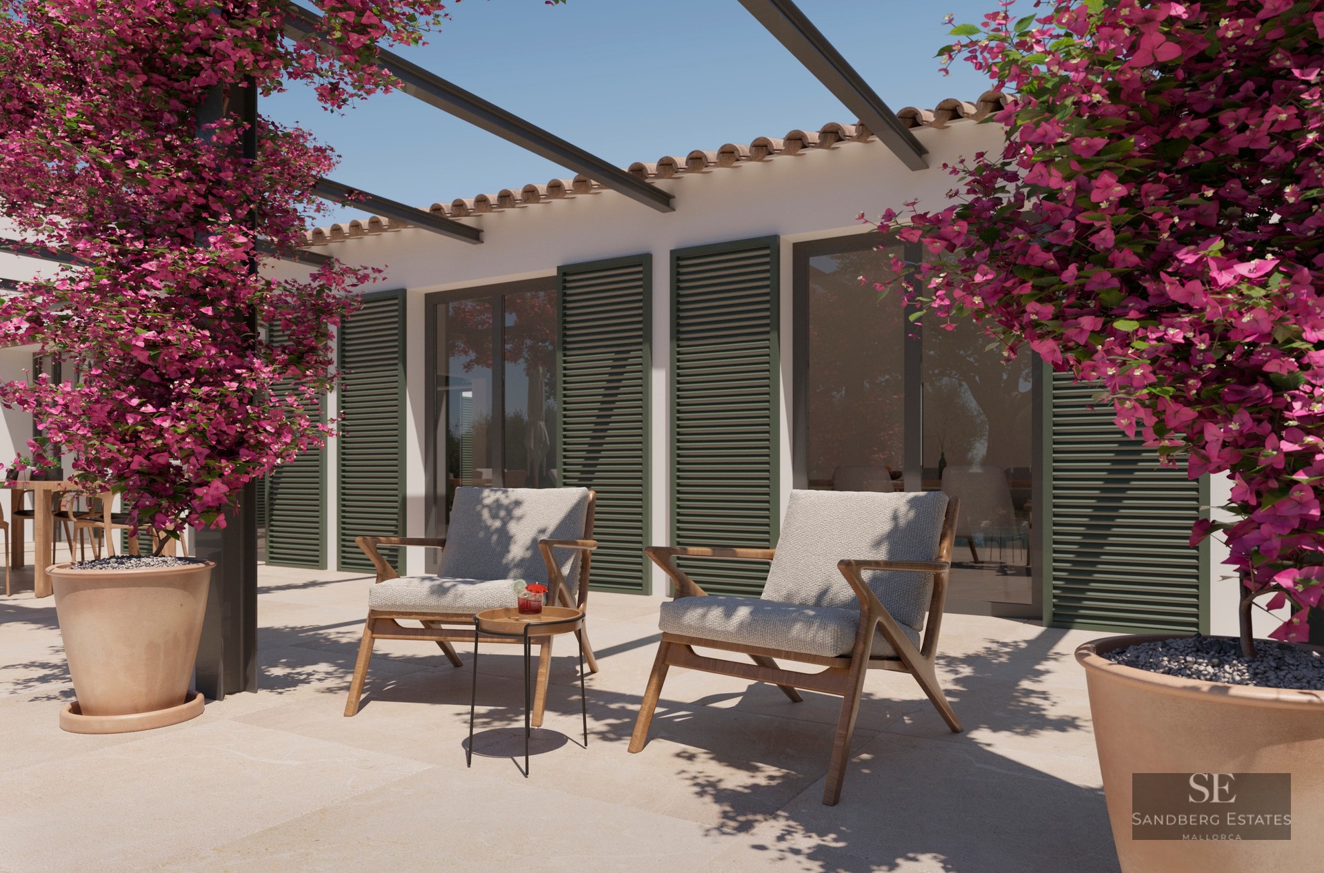 Stone terrace with two wooden armchairs, green shutters, and vibrant pink bougainvillea under a clear sky.