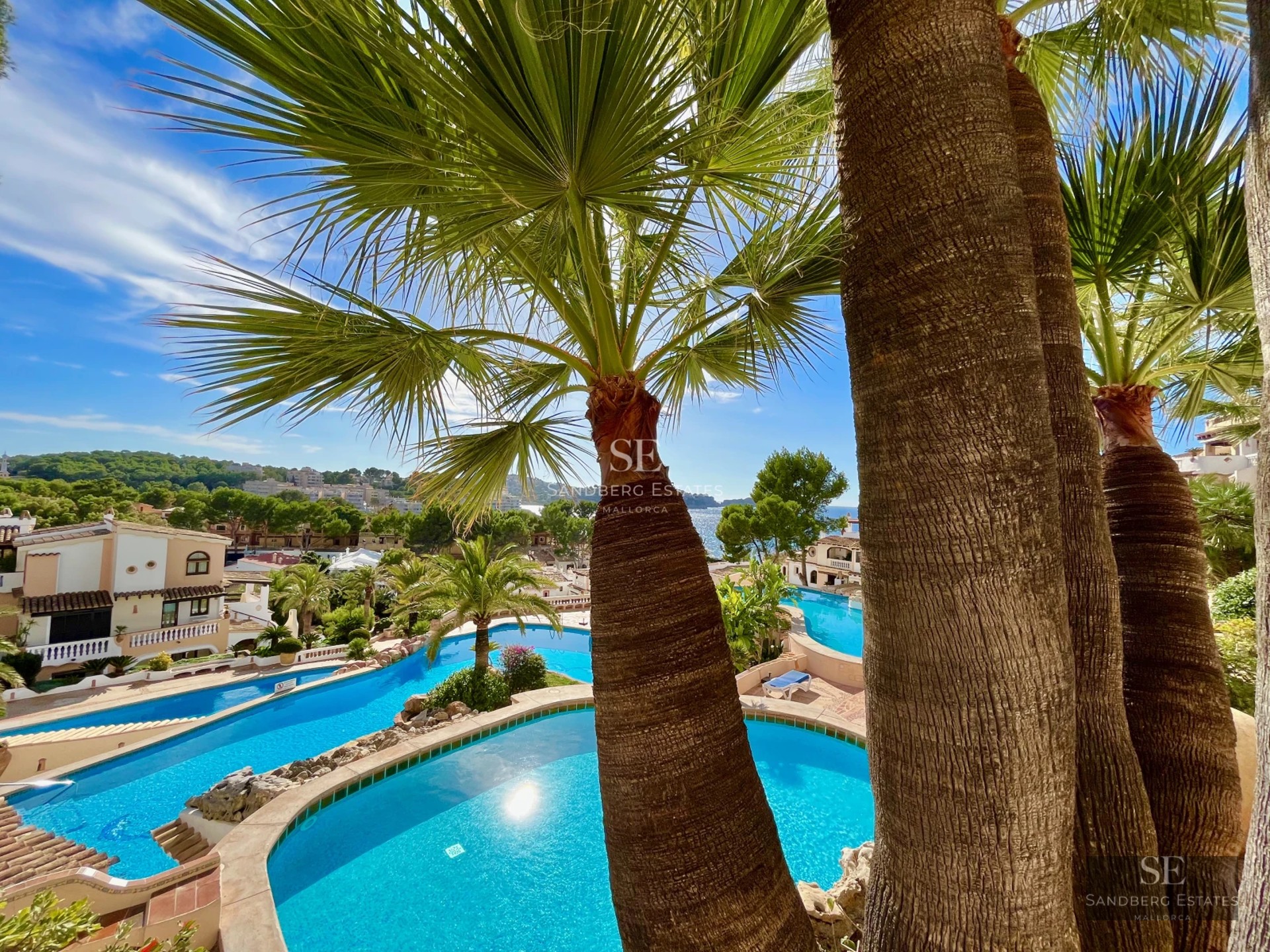 Exterior view of modern house with reflecting pool, minimalist architecture, and large windows. Warm ambient lighting.