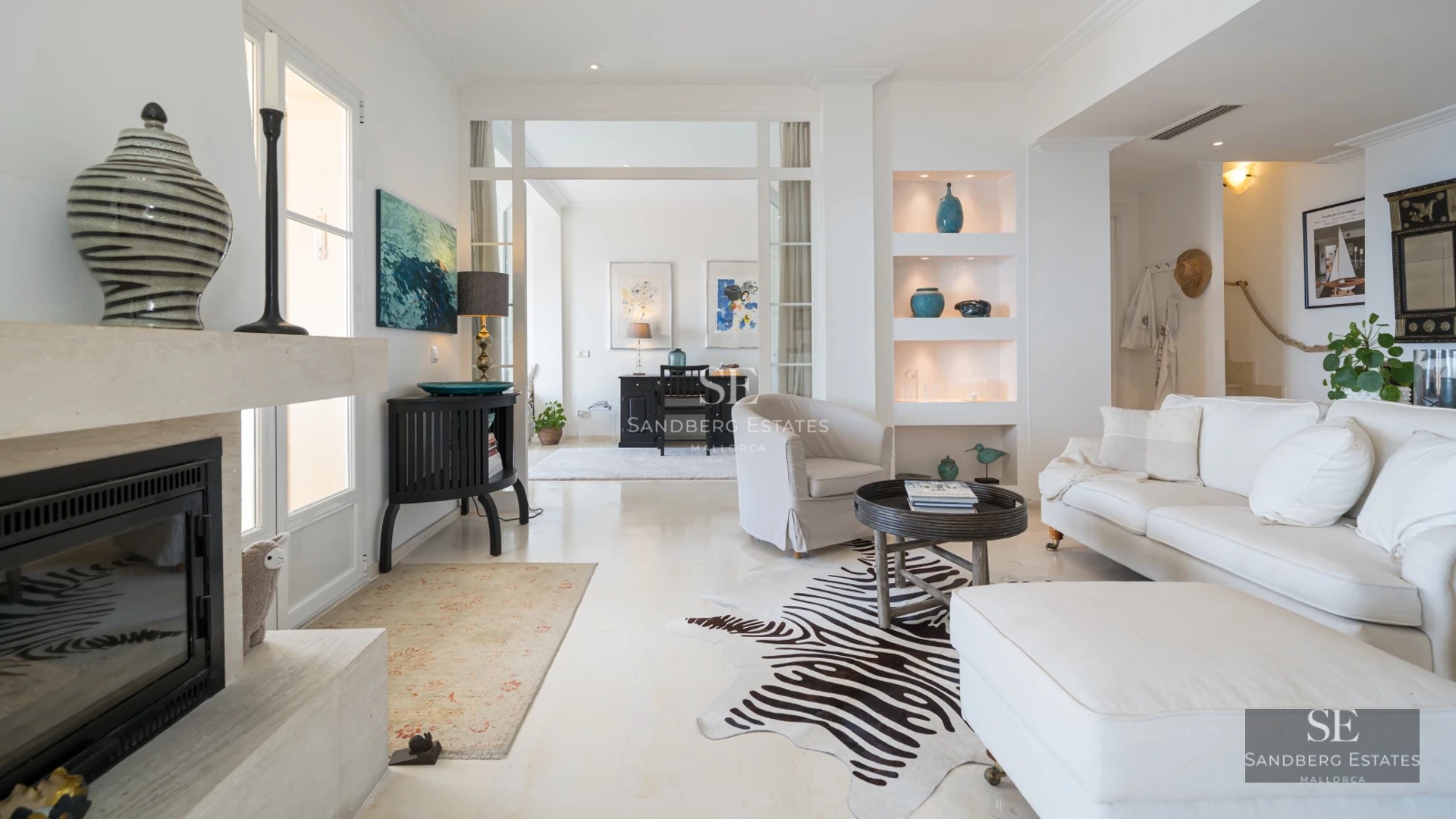 View of a modern villa with reflective pool, lush garden, and large windows offering unobstructed views.