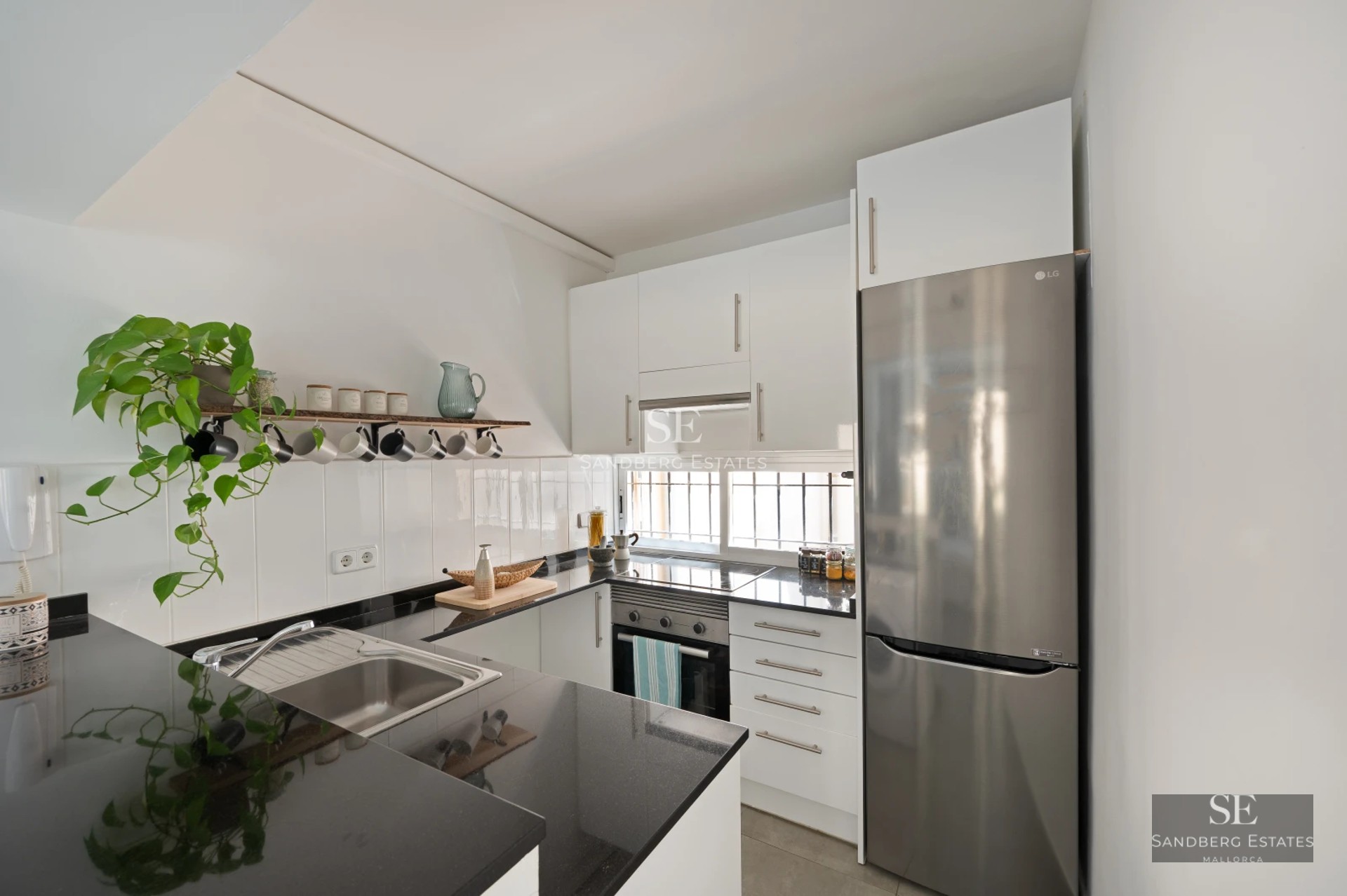 Aerial view of turquoise pool, white loungers, surrounded by lush garden. Modern architecture, clean lines and spacious open areas.