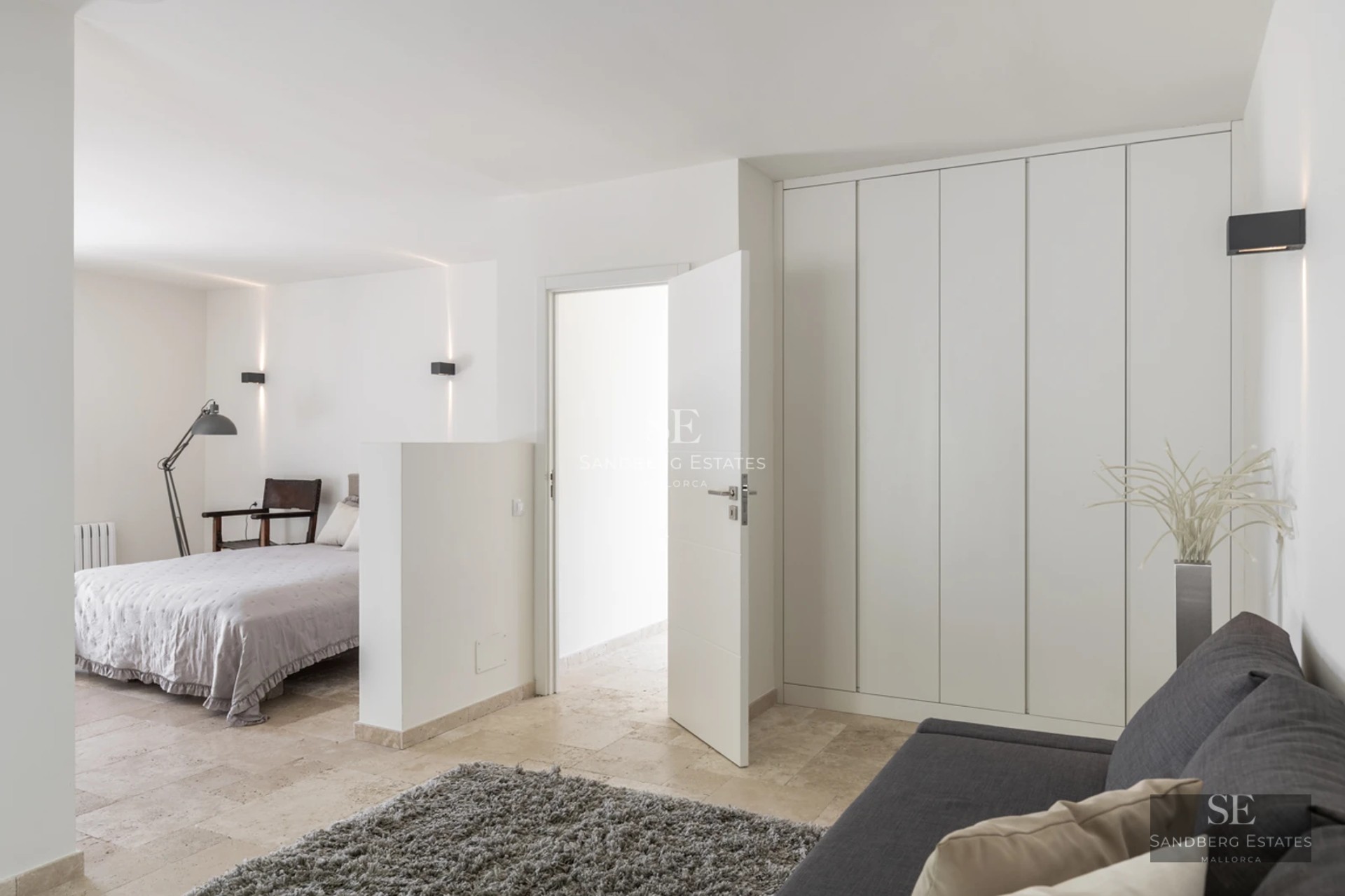 Spacious living room with fireplace, large windows, and access to terrace with pool. Modern and elegant design.